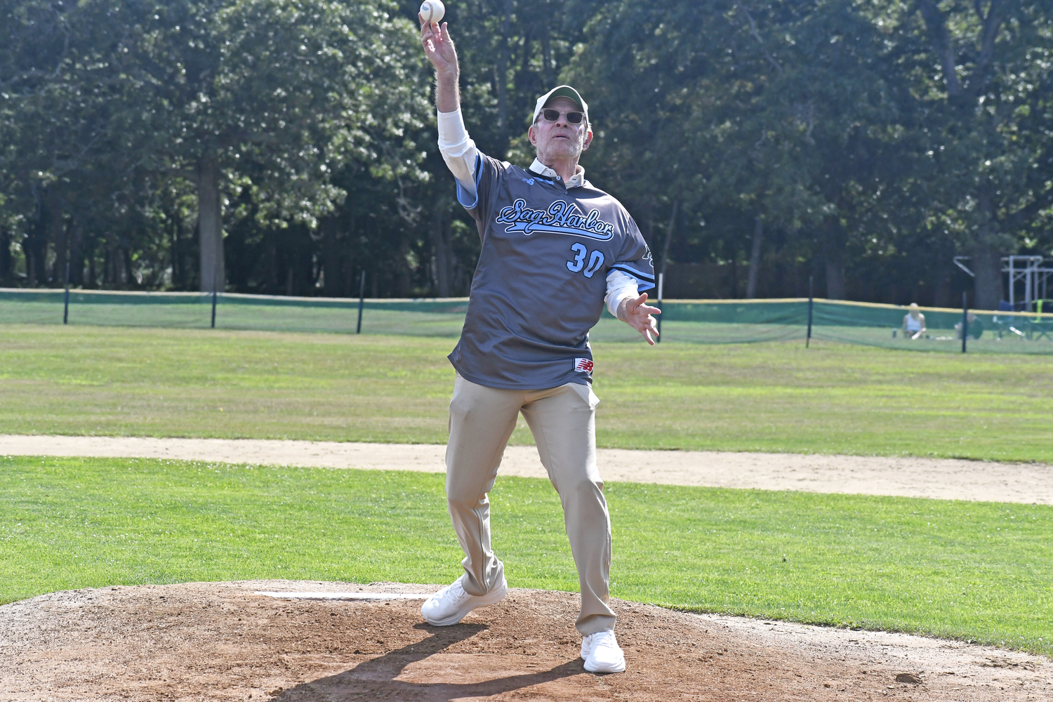 Michael Weisman, who worked for NBC Sports and was inducted into the Sports Broadcasting Hall of Fame in 2017, throws out the first pitch on Saturday afternoon.  DREW BUDD