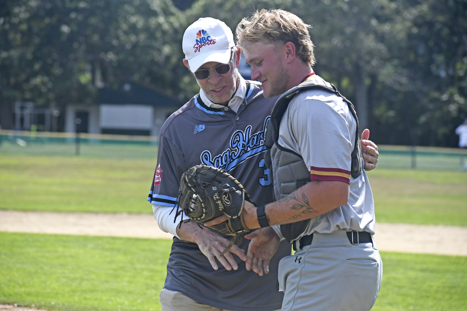 Michael Weisman shakes catcher Nick Pratt's hand after throwing out the first pitch of Saturday afternoon's HCBL All-Star Game at Mashashimuet Park in Sag Harbor.  DREW BUDD