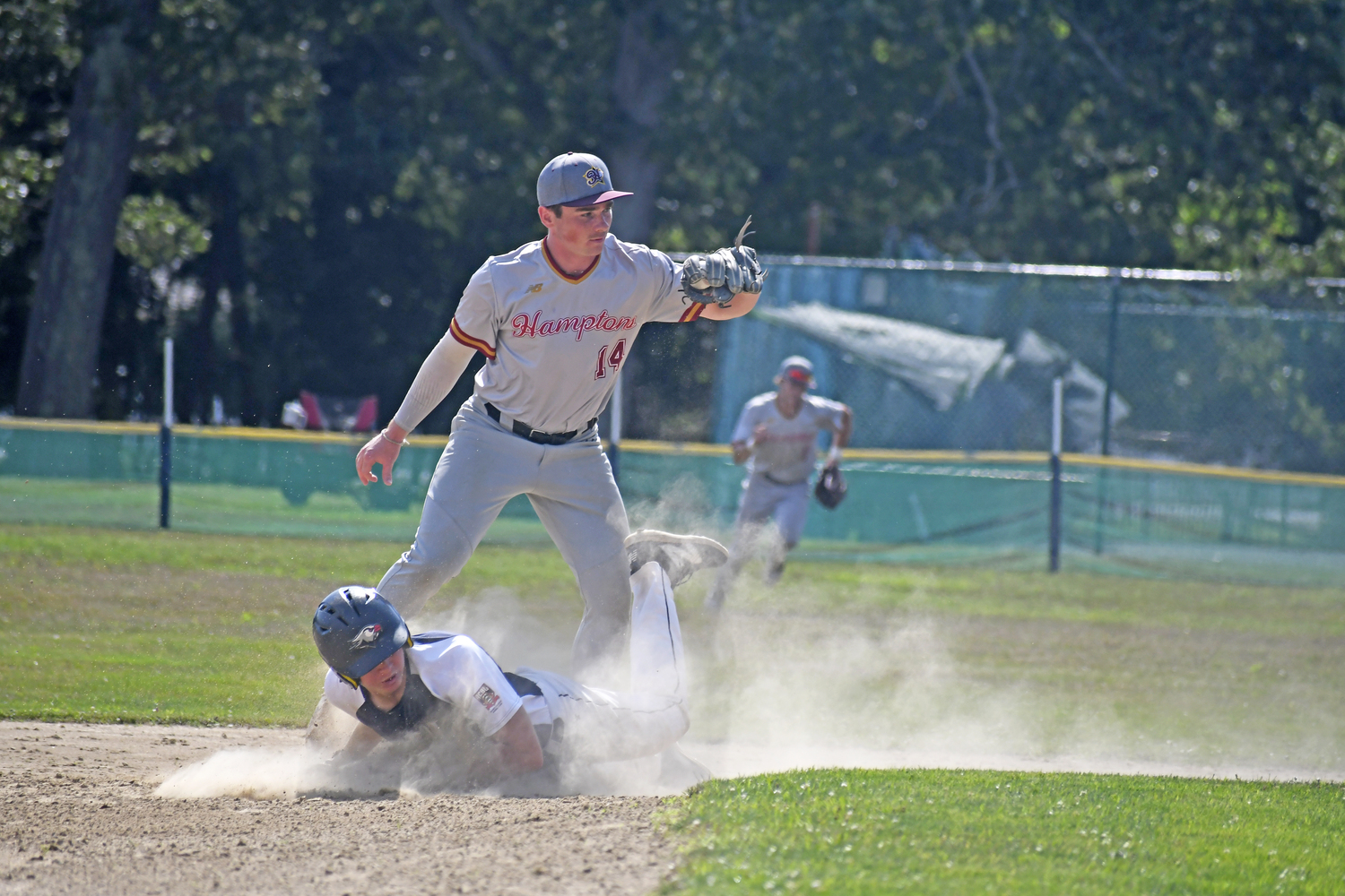 Thomas Matuszewski (North Fork/Jefferson) shows the umpire the ball after catcher Nick Pratt (North Fork/UMBC) threw out an ACBL baserunner trying to steal second base to end the top of the first.  DREW BUDD