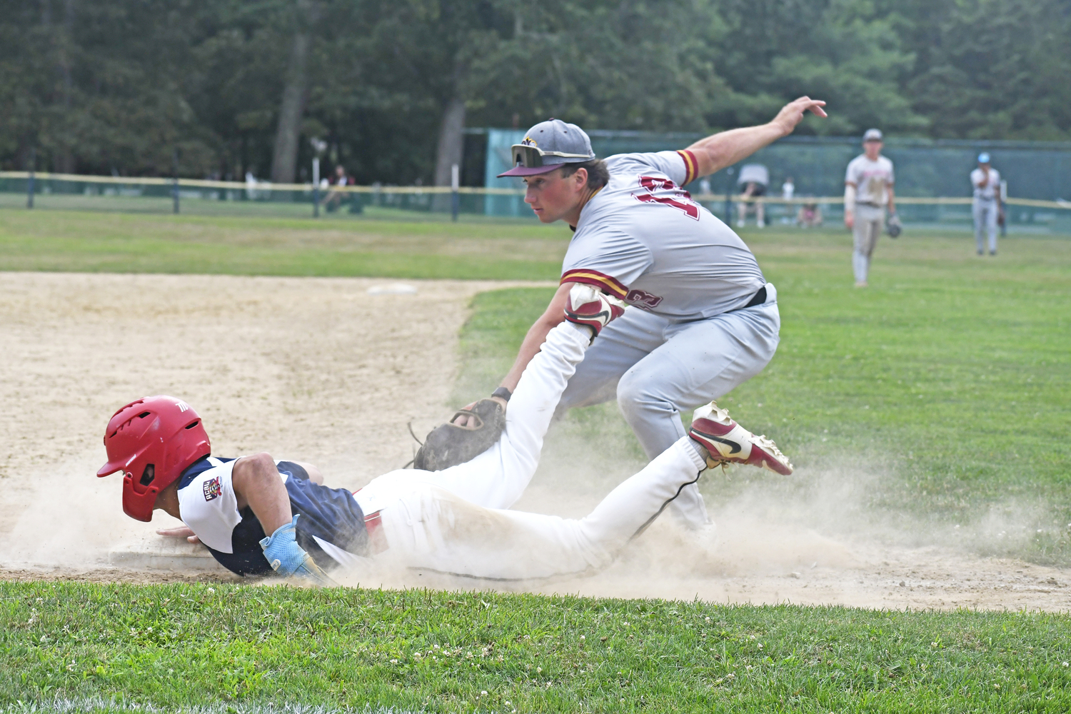 HCBL All-Star third baseman Larry Hotaling (South Shore/Villanova) nearly tags out an ACBL baserunner trying to get back to the bag.  DREW BUDD