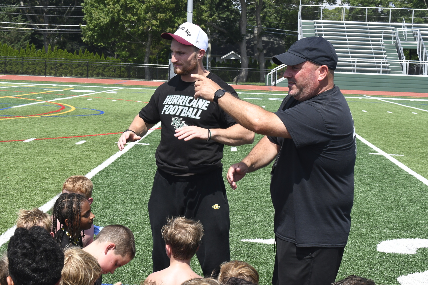 Dylan Laube and Mark Johnson both thank the Westhampton Beach varsity football players that helped out at last week's camp.  DREW BUDD