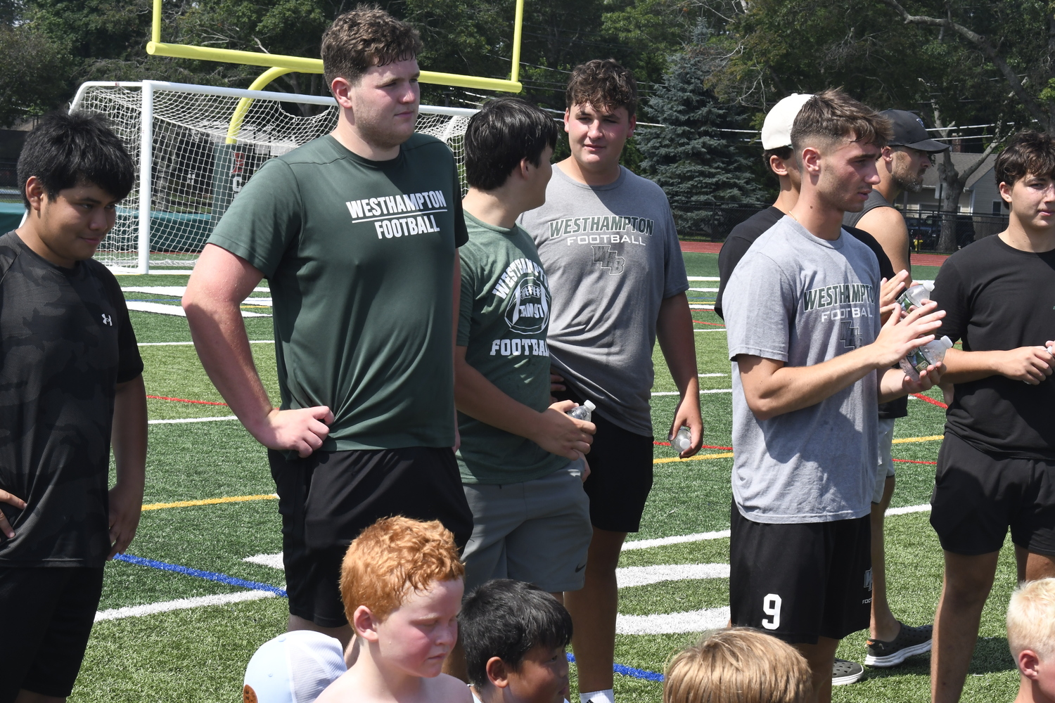 Westhampton Beach varsity football players helped out at last week's camp.  DREW BUDD