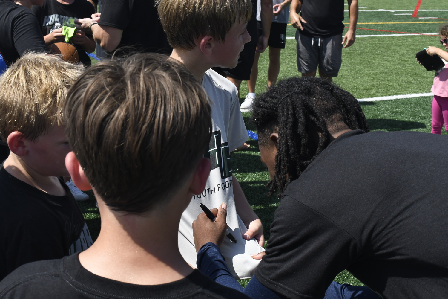 D.J. James signs his autograph.  DREW BUDD