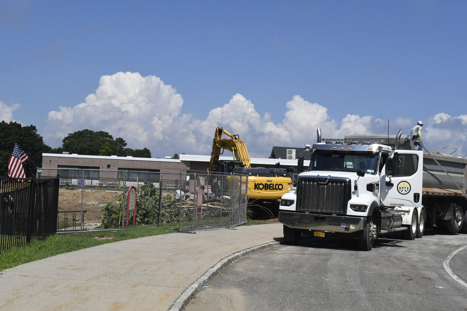 A crane works on demoing portable classrooms at Westhampton Beach Elementary School on July 16. The work had nothing to do with the varsity baseball field located behind the elementary school.  DREW BUDD