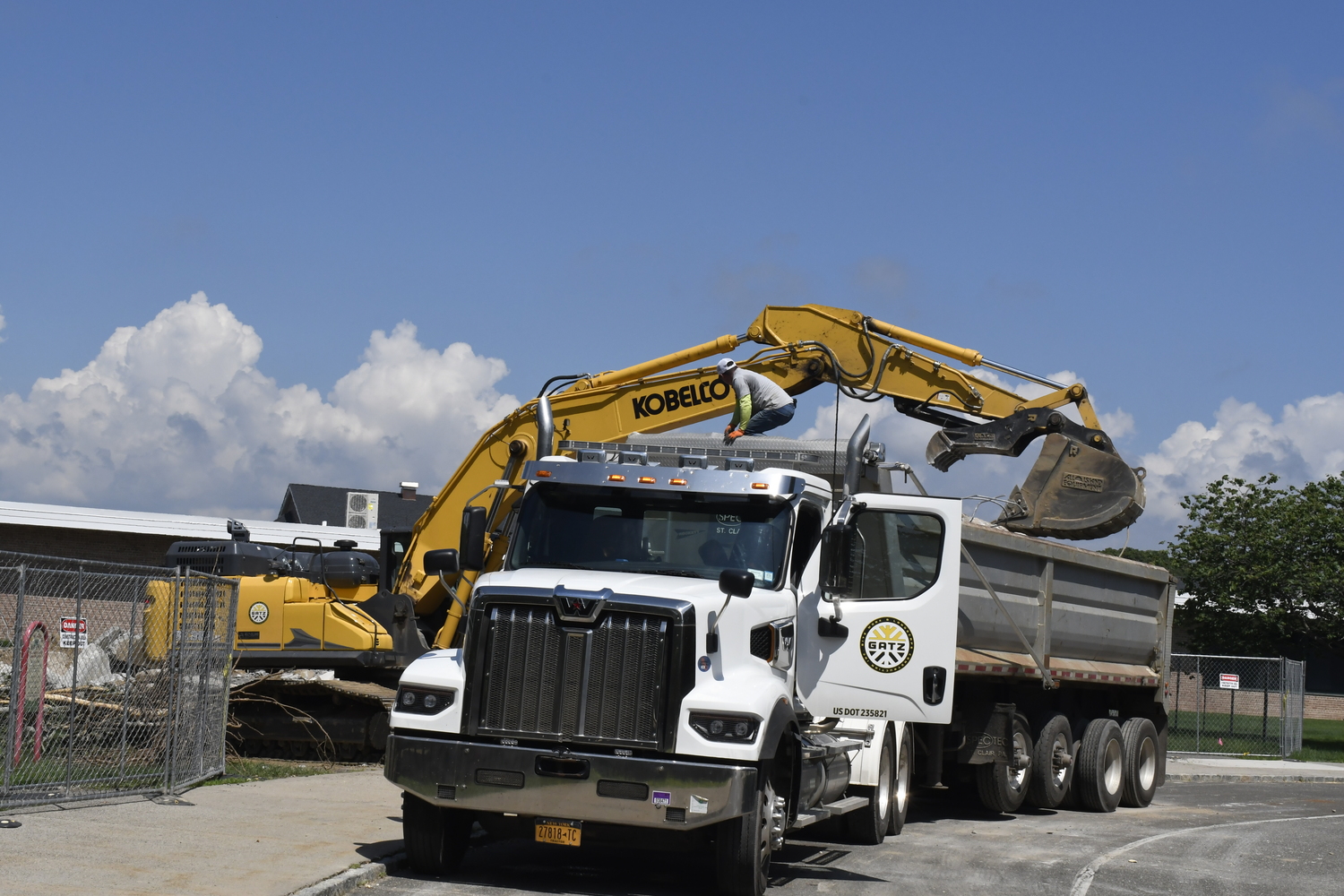 A crane works on demoing portable classrooms at Westhampton Beach Elementary School on July 16. The work had nothing to do with the varsity baseball field located behind the elementary school.  DREW BUDD