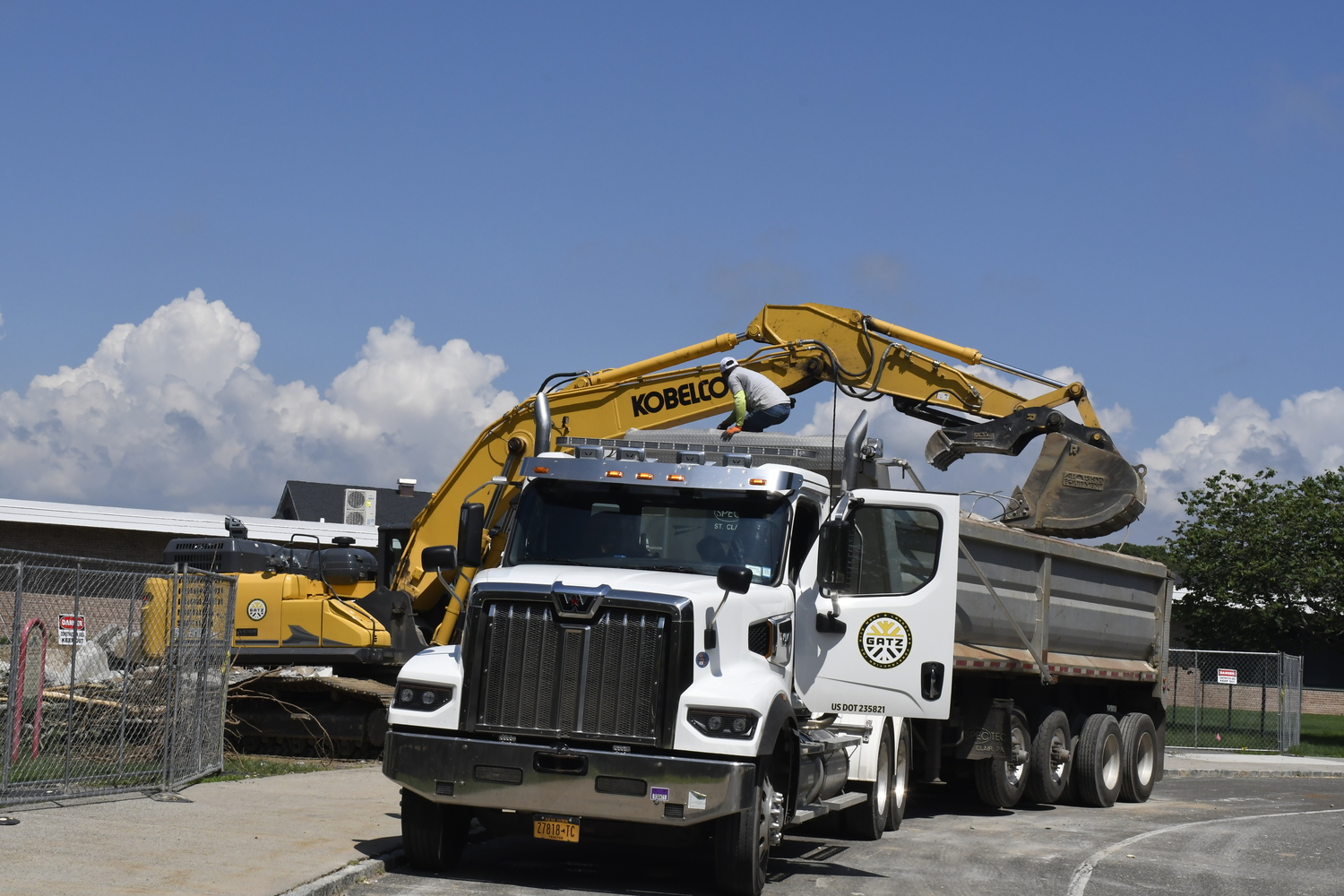 A crane works on demoing portable classrooms at Westhampton Beach Elementary School on July 16. The work had nothing to do with the varsity baseball field located behind the elementary school.  DREW BUDD