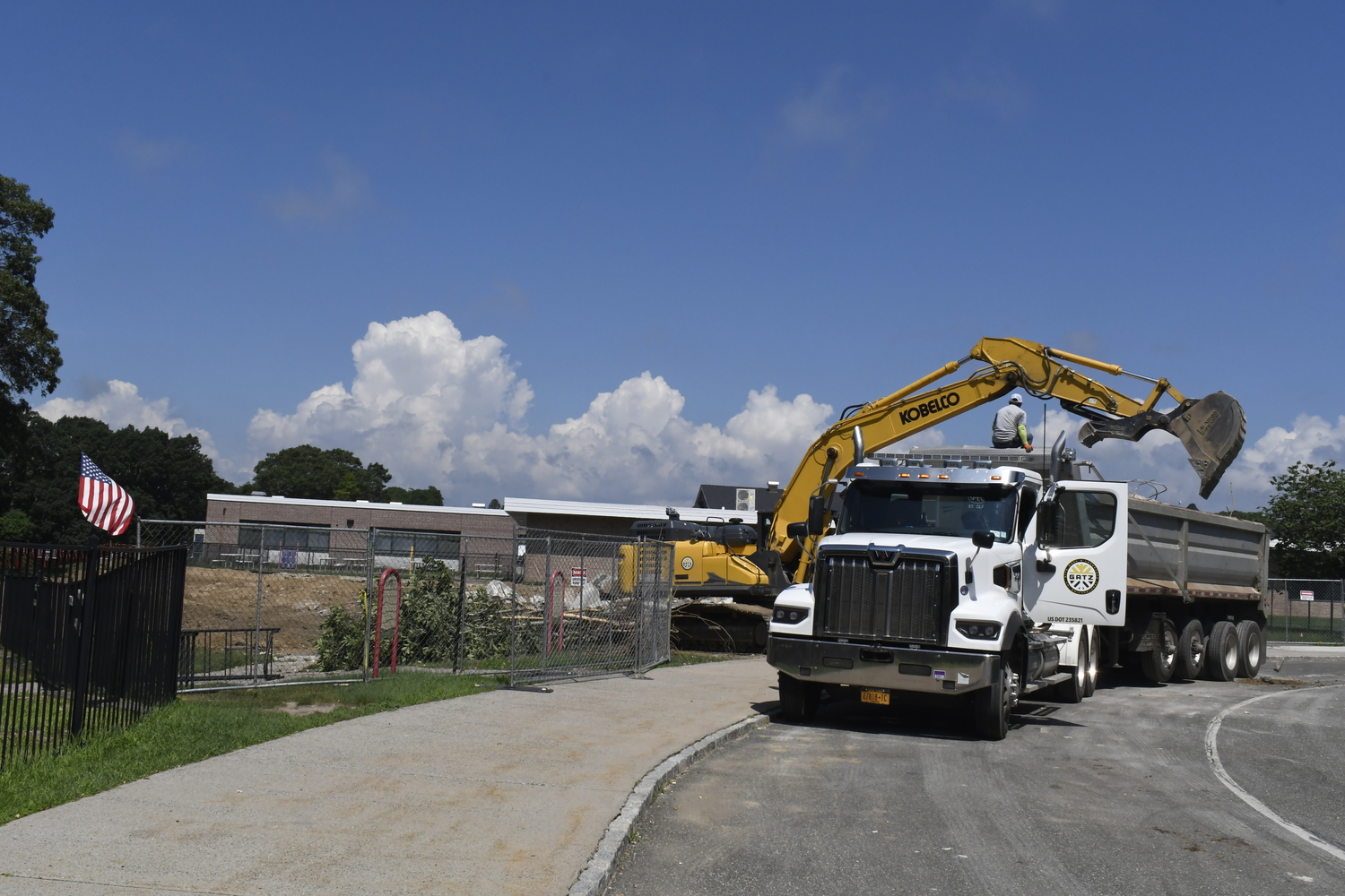 A crane works on demoing portable classrooms at Westhampton Beach Elementary School on July 16. The work had nothing to do with the varsity baseball field located behind the elementary school.  DREW BUDD