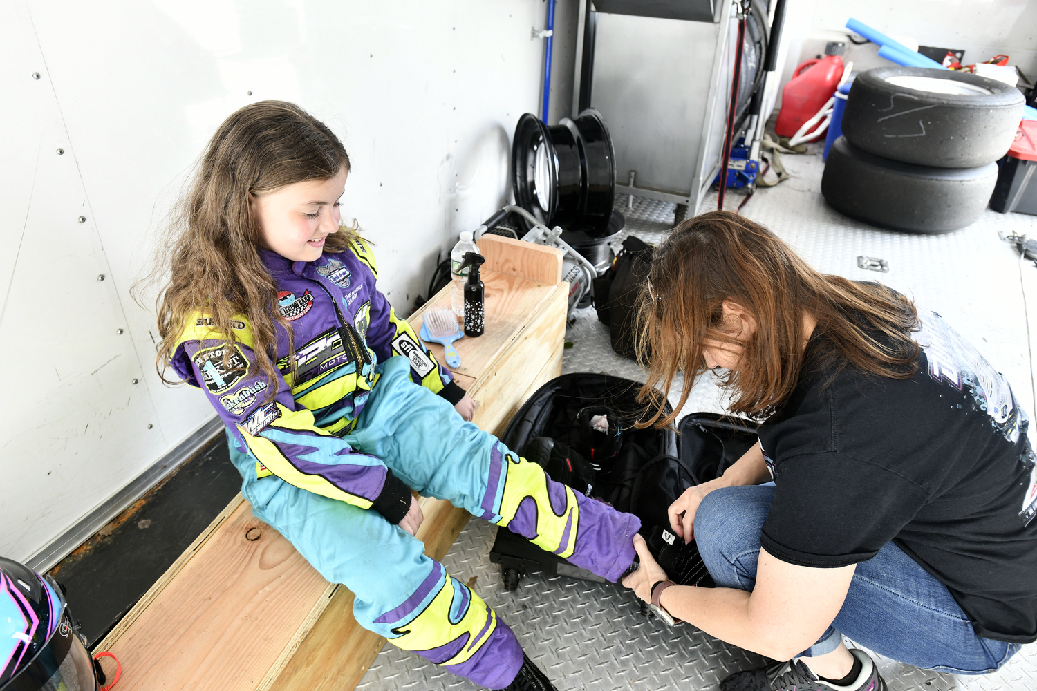 Scarlett Dumicich suits up with help from her mom, Melanie.  DANA SHAW