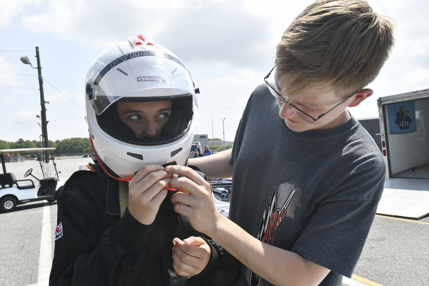Emily Gatz gets help with her helmet from Chance Lutz.  DANA SHAW