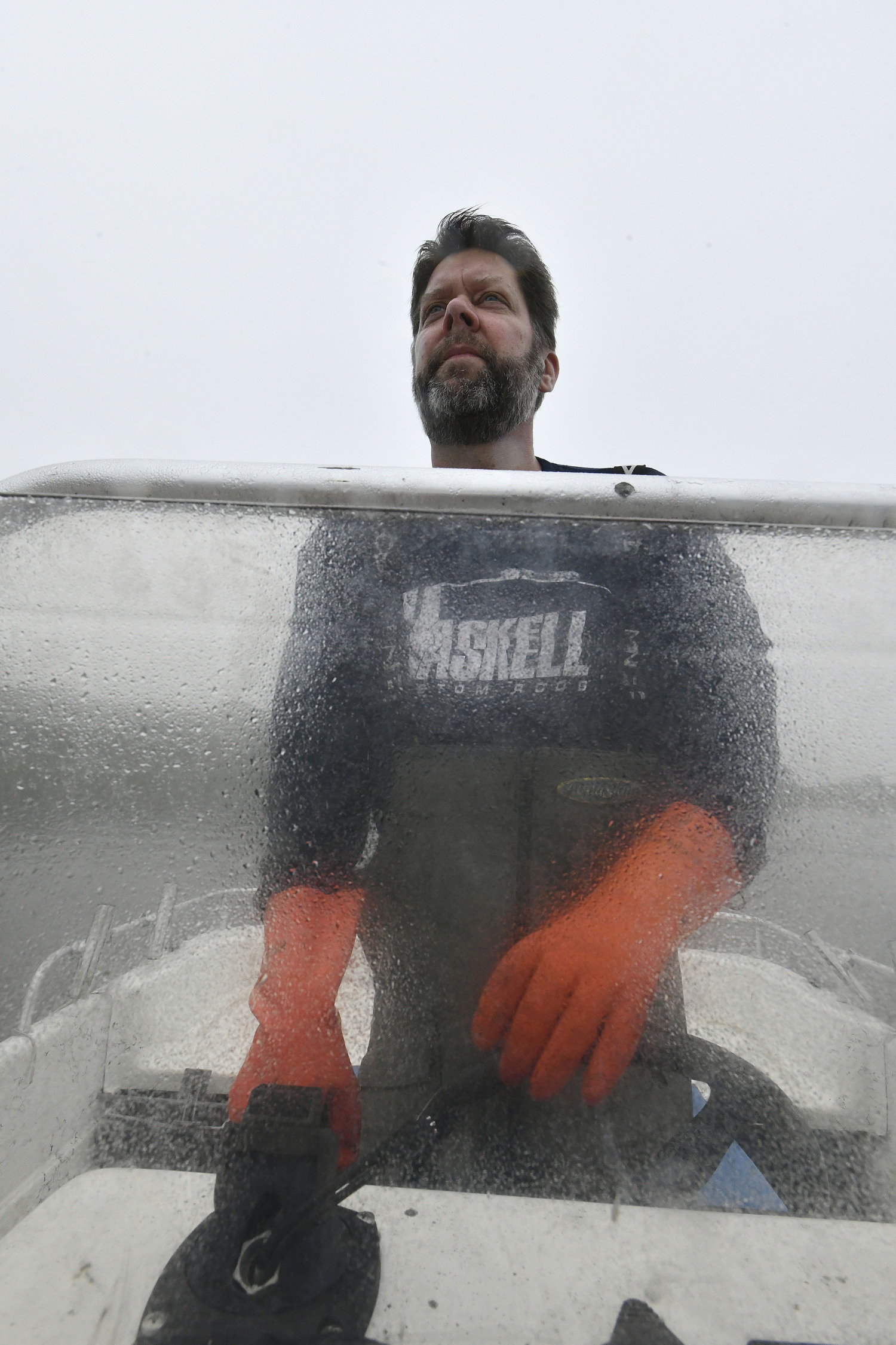 Captain Peter Haskell checks crab pots on Weesuck Creek on a foggy, misty day.  DANA SHAW
