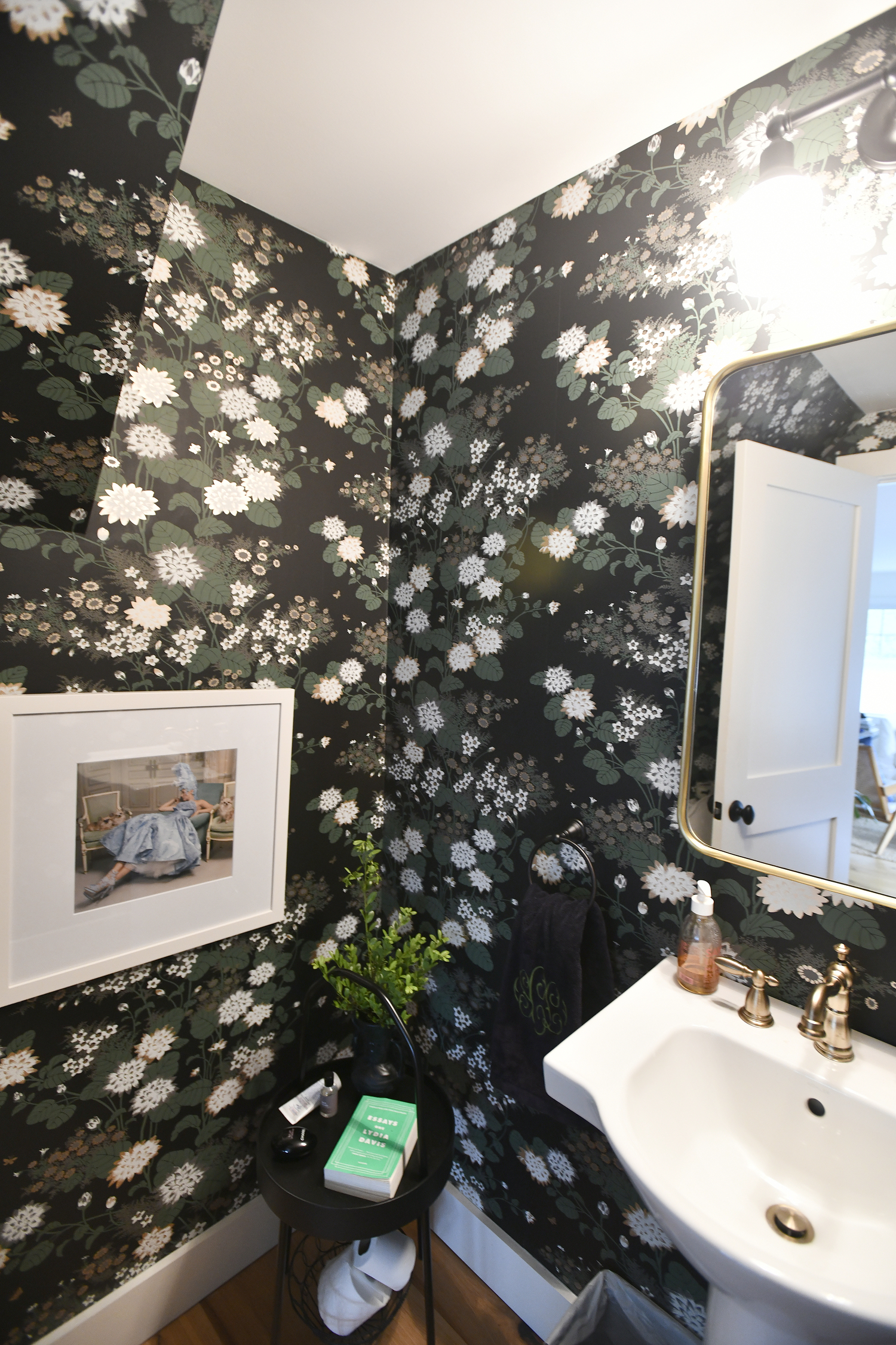 The downstairs bathroom features bold, yet feminine wallpaper.   DANA SHAW