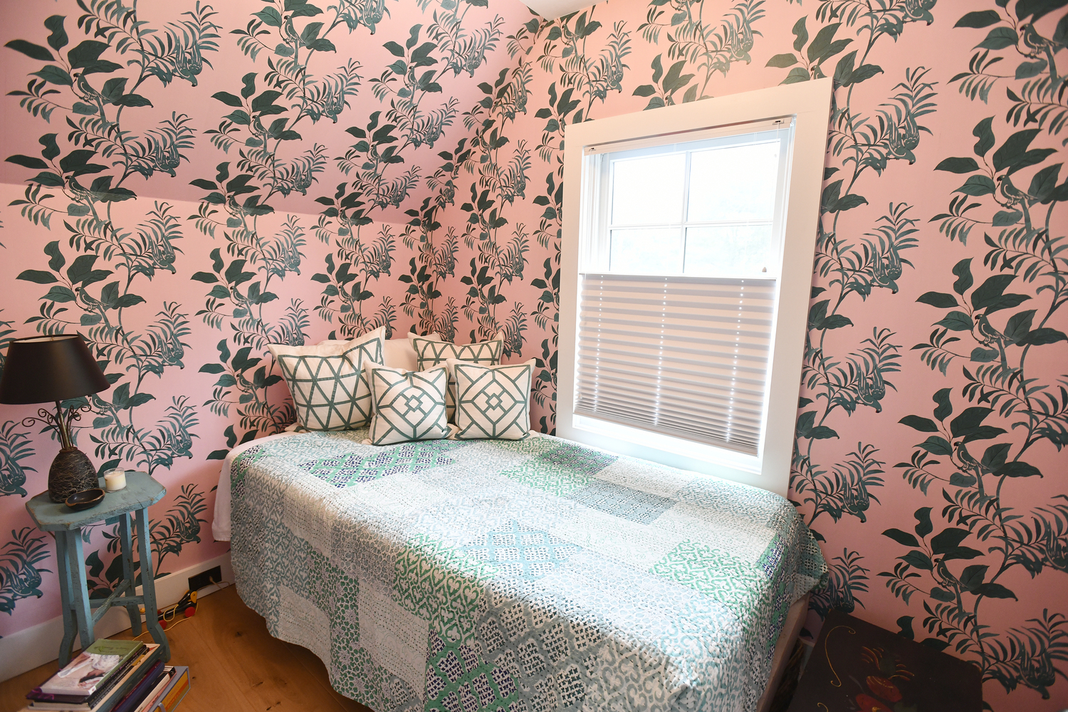 the upstairs guest bedroom offers pink, floral wallpaper.   DANA SHAW