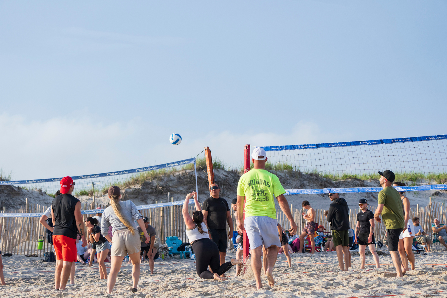 The 12 volleyball courts at Tiana Beach in Hampton Bays are packed on Tuesday and Thursday nights for leagues organized by East End Volleyball, which is on the cusp of its 50th anniversary. LORI HAWKINS