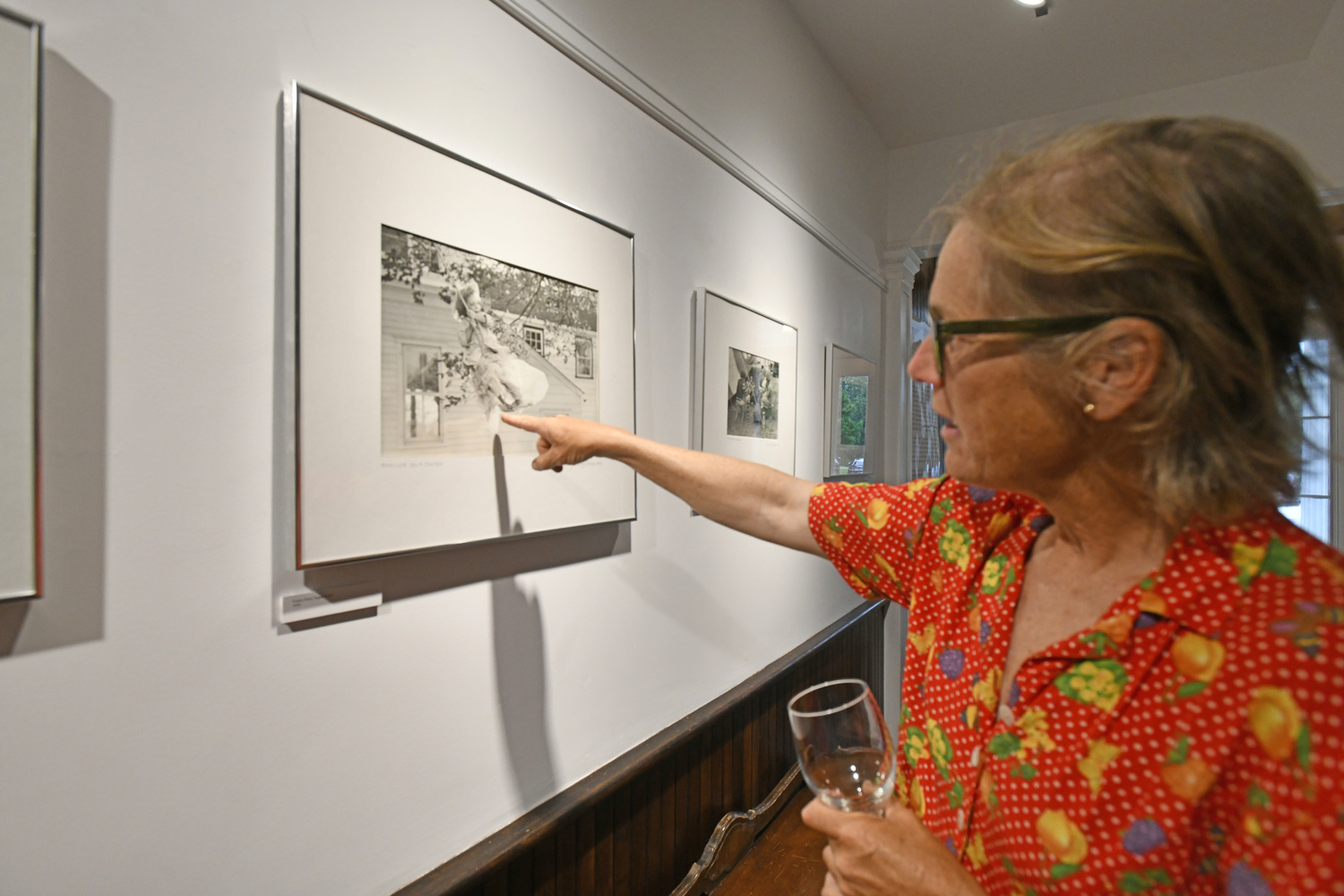 Merilee Foster with a photo of herself as a child taken by Pingree Louchheim at the opening of 
