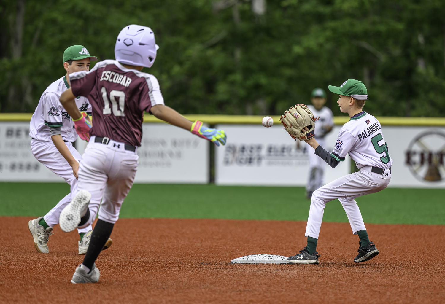 East End second baseman Charlie Palamidessi receives the ball from shortstop Gabe Dawson with Southampton's Josiah Escobar bearing down on him.  MARIANNE BARNETT