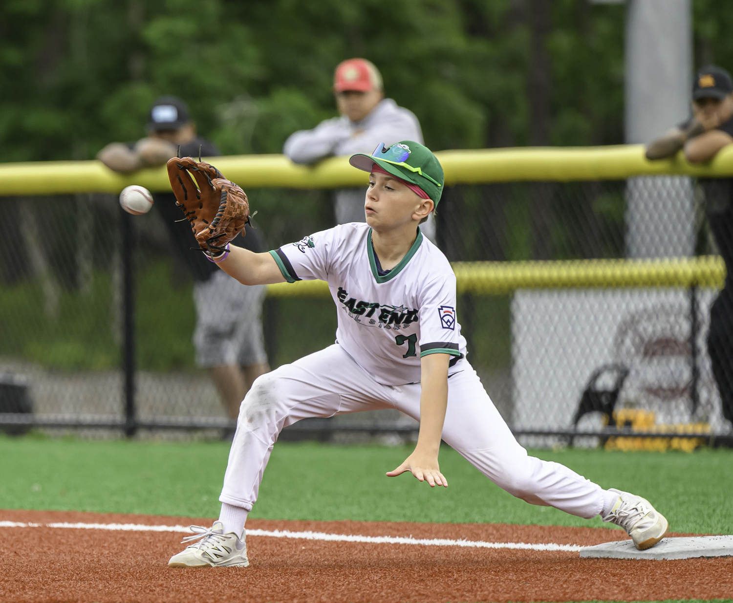 Lukas Olsson stretches for the out at first.  MARIANNE BARNETT
