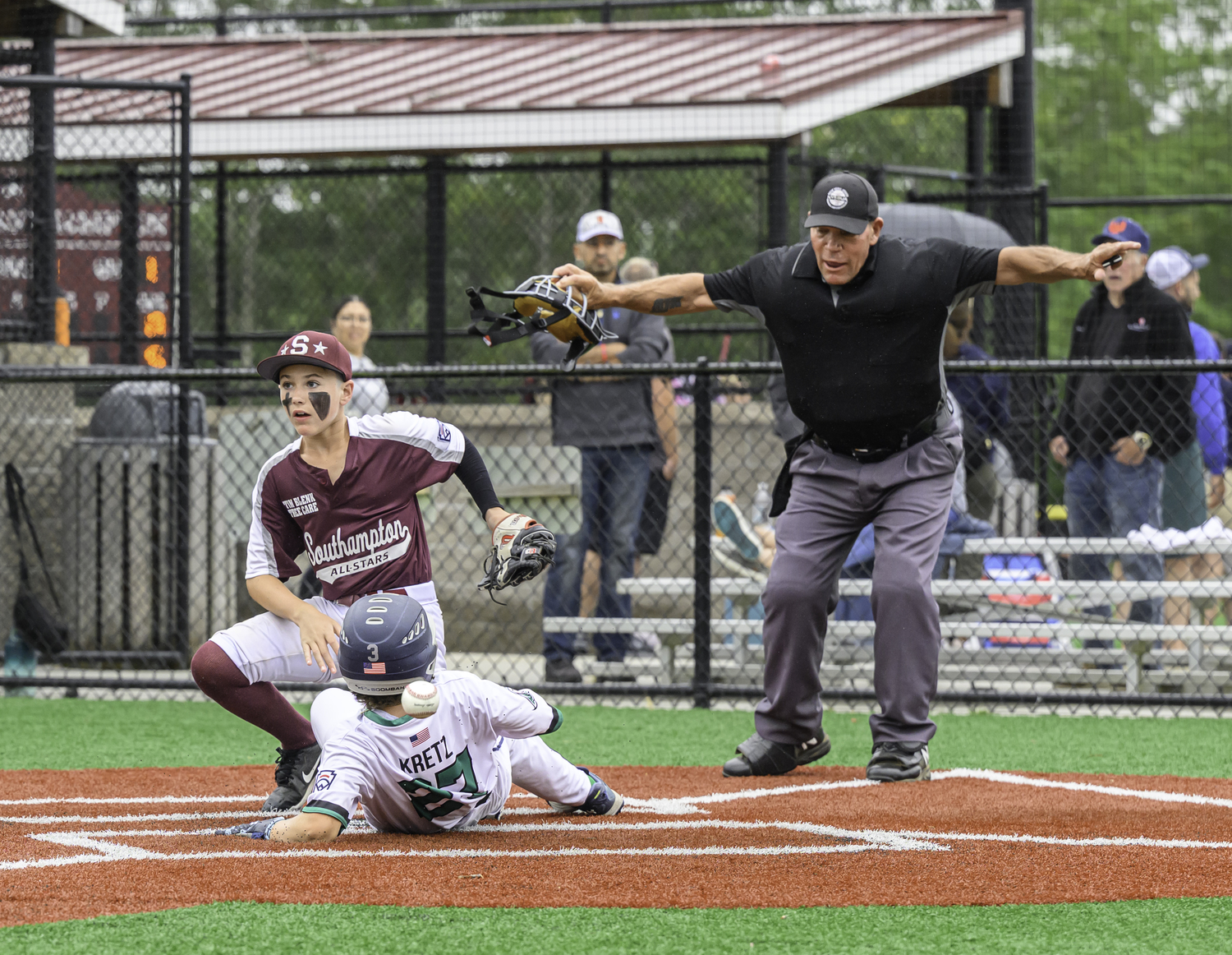 Kevin Kretz scores the first run of the game for East End on Saturday.  MARIANNE BARNETT