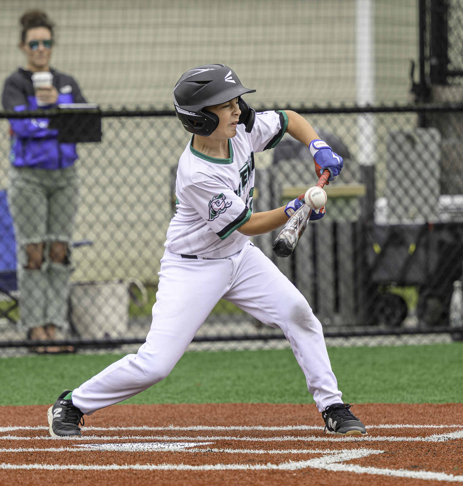 An East End player tries to bunt the ball.  MARIANNE BARNETT