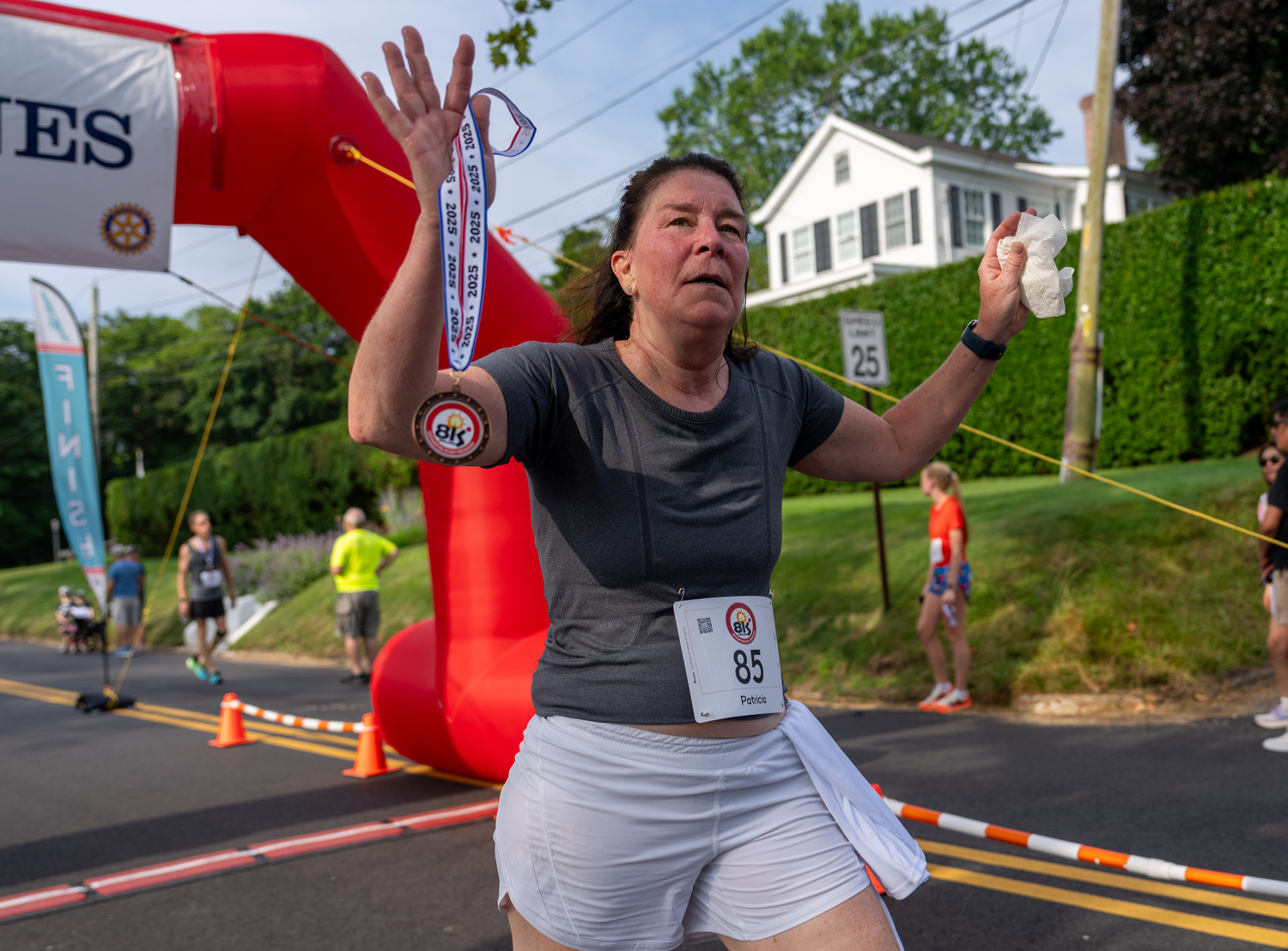 Patricia Mattingly of Southampton is happy, she's crossed the finish and has her medal.  RON ESPOSITO