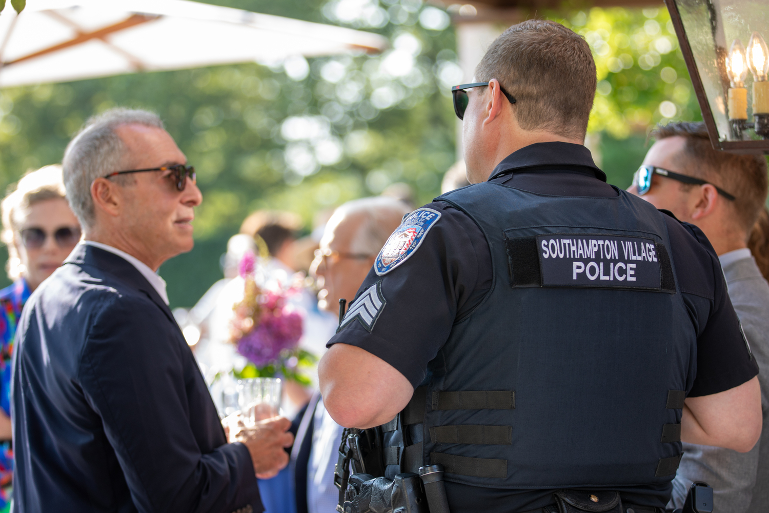 Southampton Public Safety Foundation co-founder Michael Falk chats with members of the Southampton Village Police force. PB PHOTO CONCIERGE