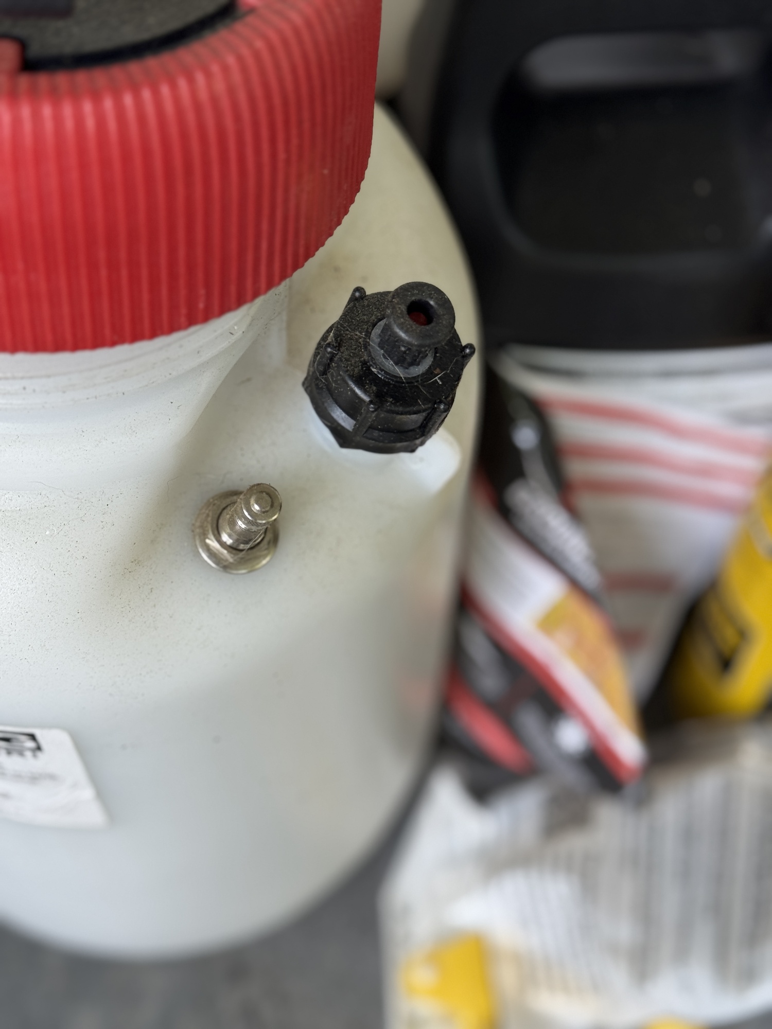This sprayer can be hand pumped or pressurized via the port on the left using a compressor. The black knob on the right is a pressure release valve, but this is rare on inexpensive hand sprayers though the device will keep you from getting the sprayer contents released toward your face as long as you use it before you take the tank top off.   ANDREW MESSINGER