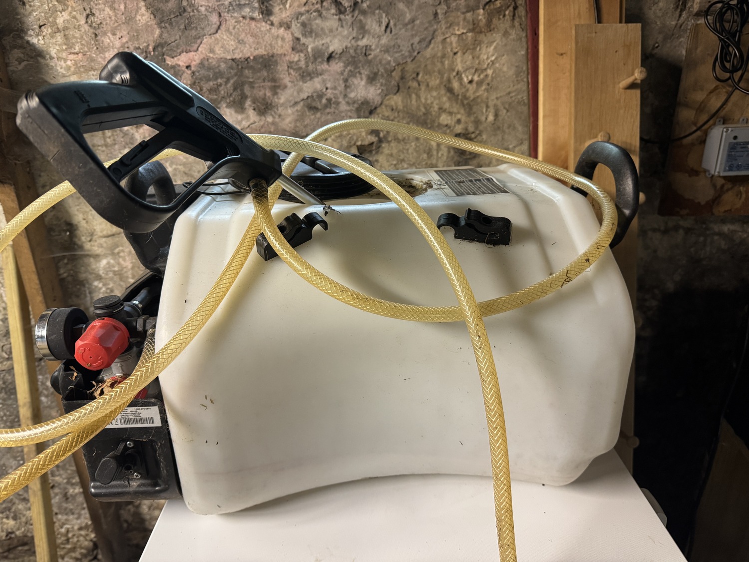 A retired 10-gallon battery-operated sprayer with an 8-foot hose. If you have a cart that this will fit in it is an option for larger properties, but I’ve found the couplings and worm screw connections a constant problem when it comes to leaks. The motors seem to burn out fairly fast. You also need to have access to a 12-volt battery (via alligator clamps) or a cigarette lighter that some smaller tractors have. ANDREW MESSINGER