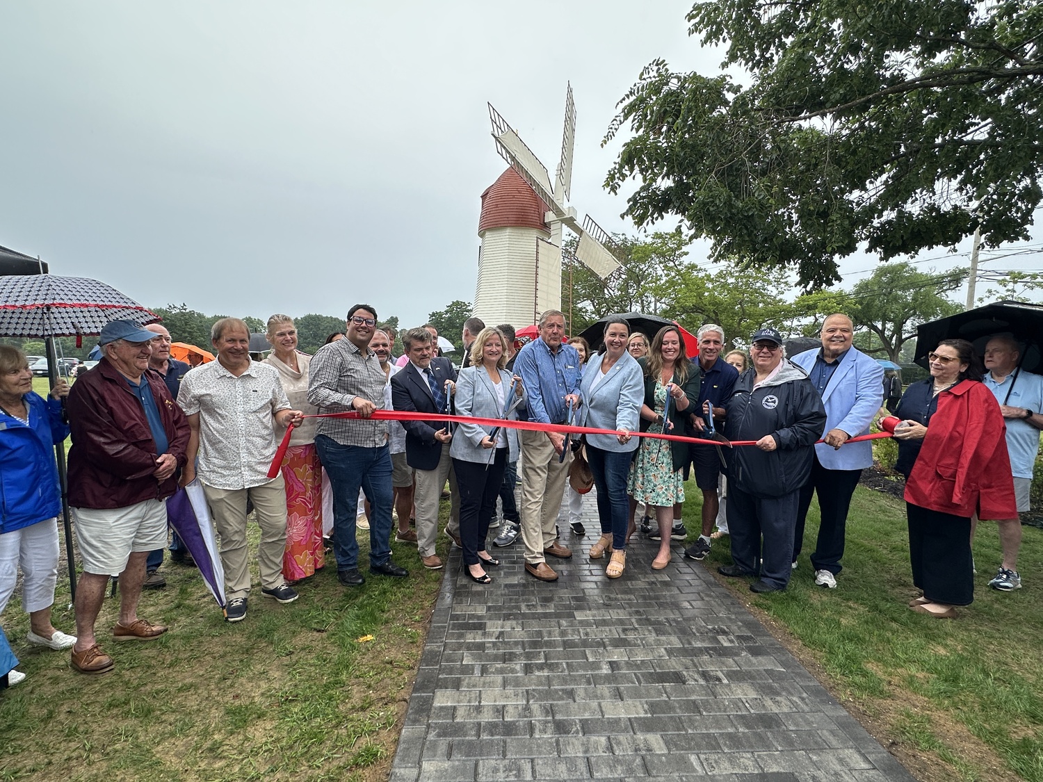 Westhampton Beach Village and other local officials cutting the ribbon at the Gov. John Adams Dix Windmill on Wednesday, July 2. DAN STARK