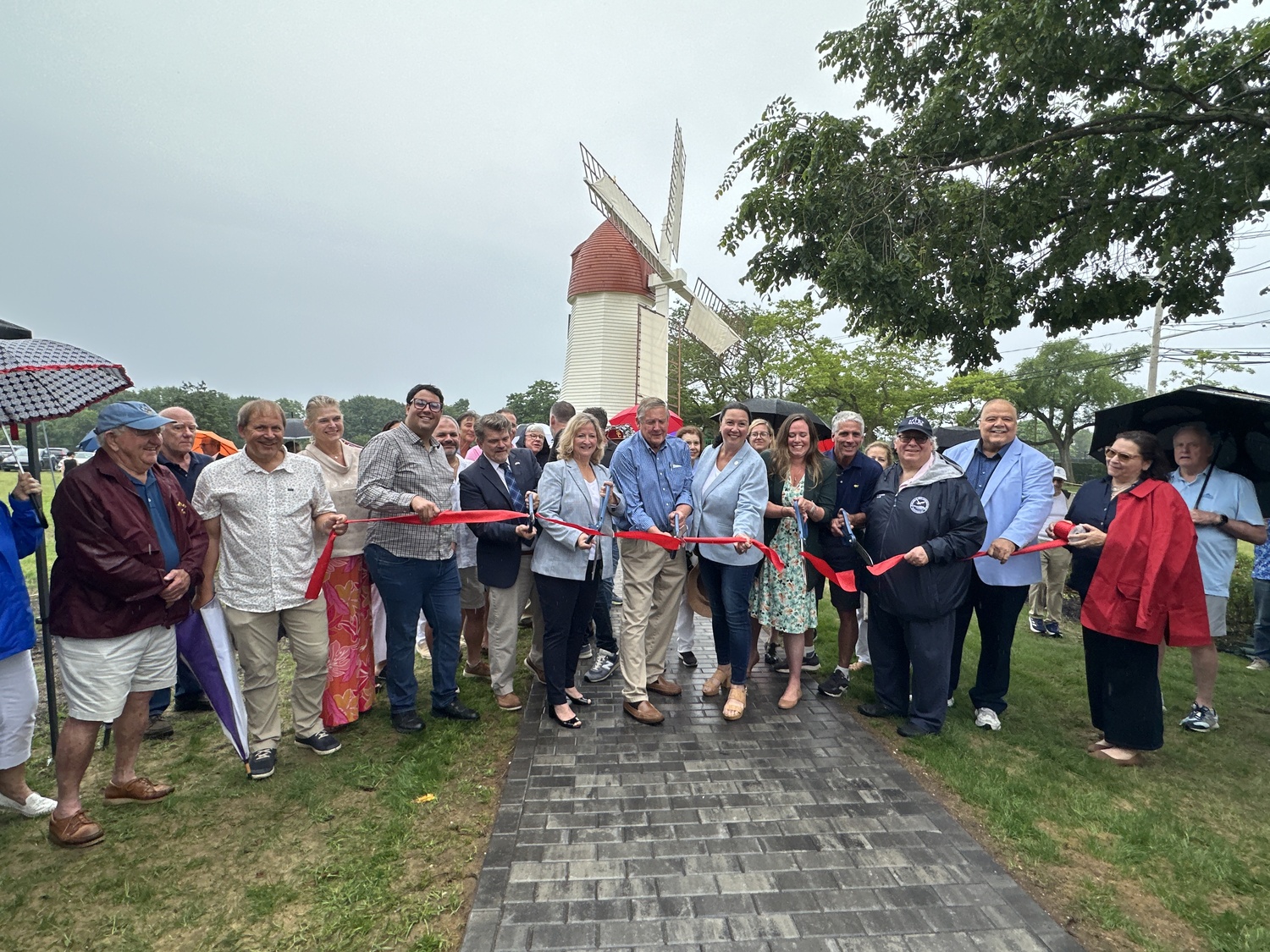 Westhampton Beach Village and other local officials cutting the ribbon at the Gov. John Adams Dix Windmill on Wednesday, July 2. DAN STARK