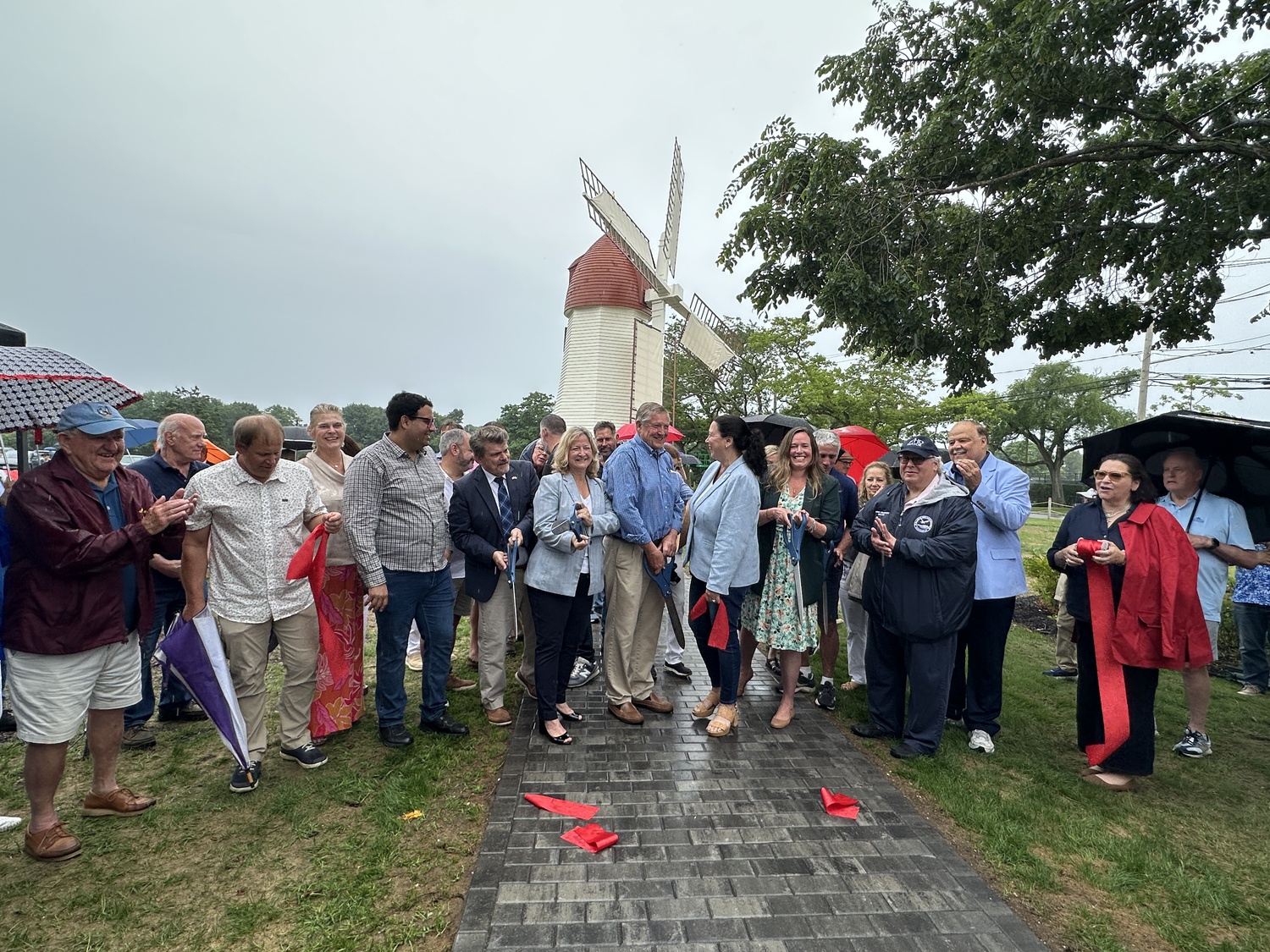 Westhampton Beach Village and other local officials cutting the ribbon at the Gov. John Adams Dix Windmill on Wednesday, July 2. DAN STARK