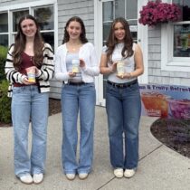 Three students from Westhampton Beach High School - Allie Barry, Liz Sultan, Michelle Rodriguez - have their designs featured on Hampton Coffee cups. COURTESY AMY DEMCHAK-CONNELL