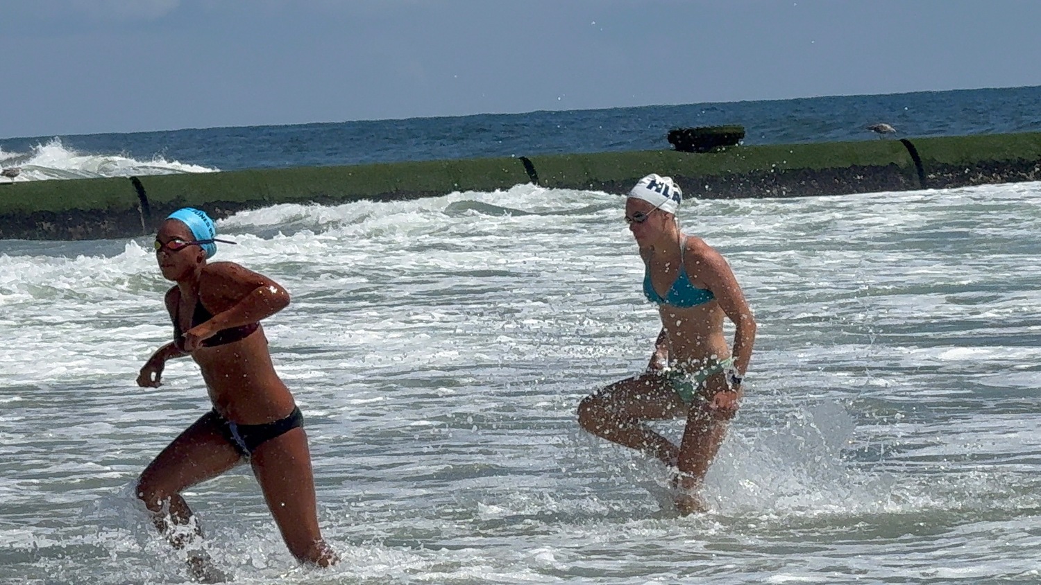 Heidi Rizzo, right, coming out of the surf.    COURTESY SEAN KNIGHT