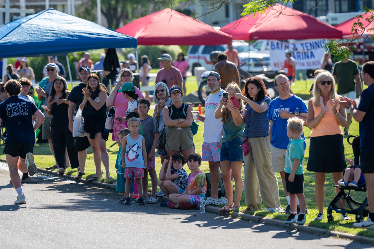 Onlookers root on family and friends participating in Saturday's race.   RON ESPOSITO
