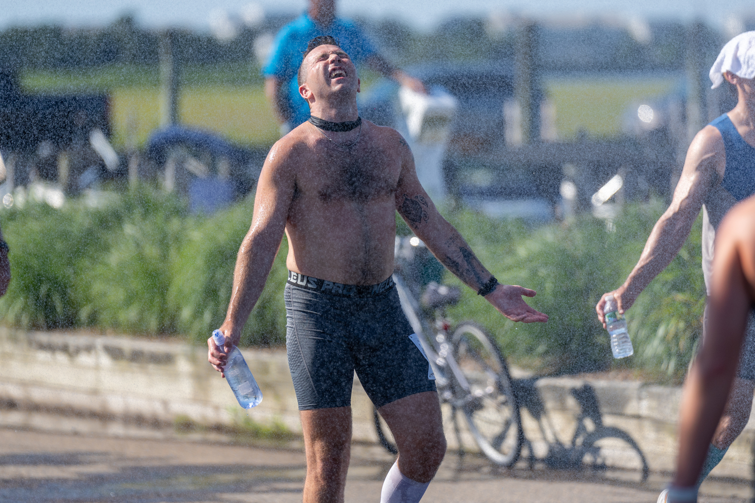 A race participant appreciates the shower provided by the Westhampton Beach Fire Department.  RON ESPOSITO