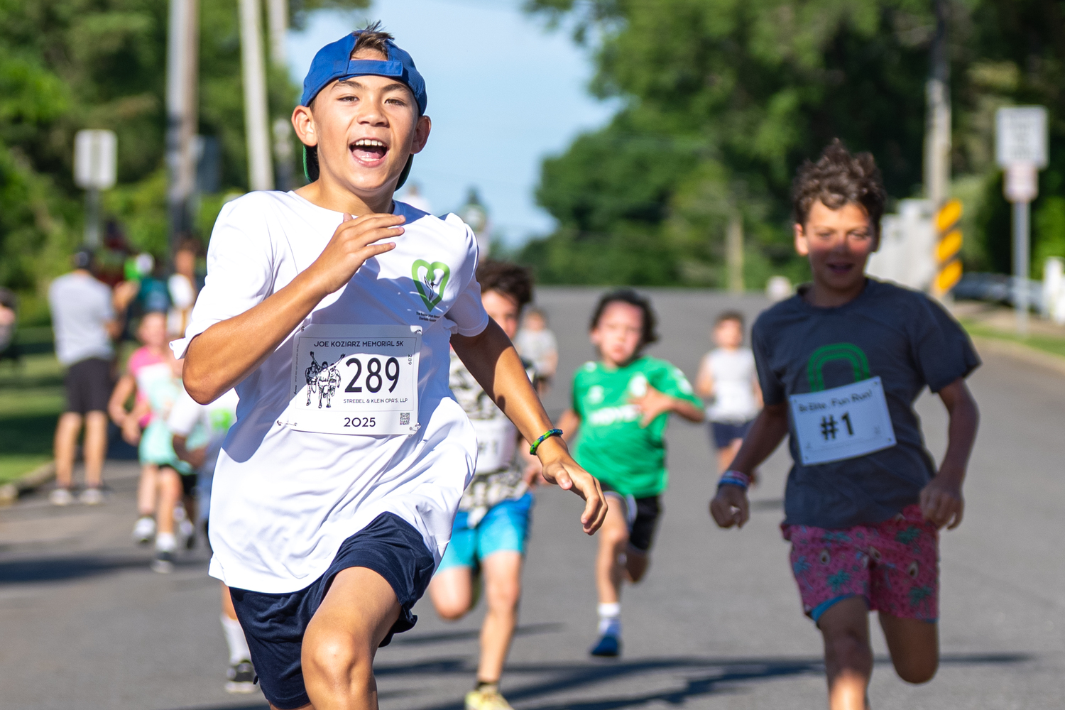 Charlie Sparke of Vernon, Connecticut, leads the pack of young runners across the finish line during the 