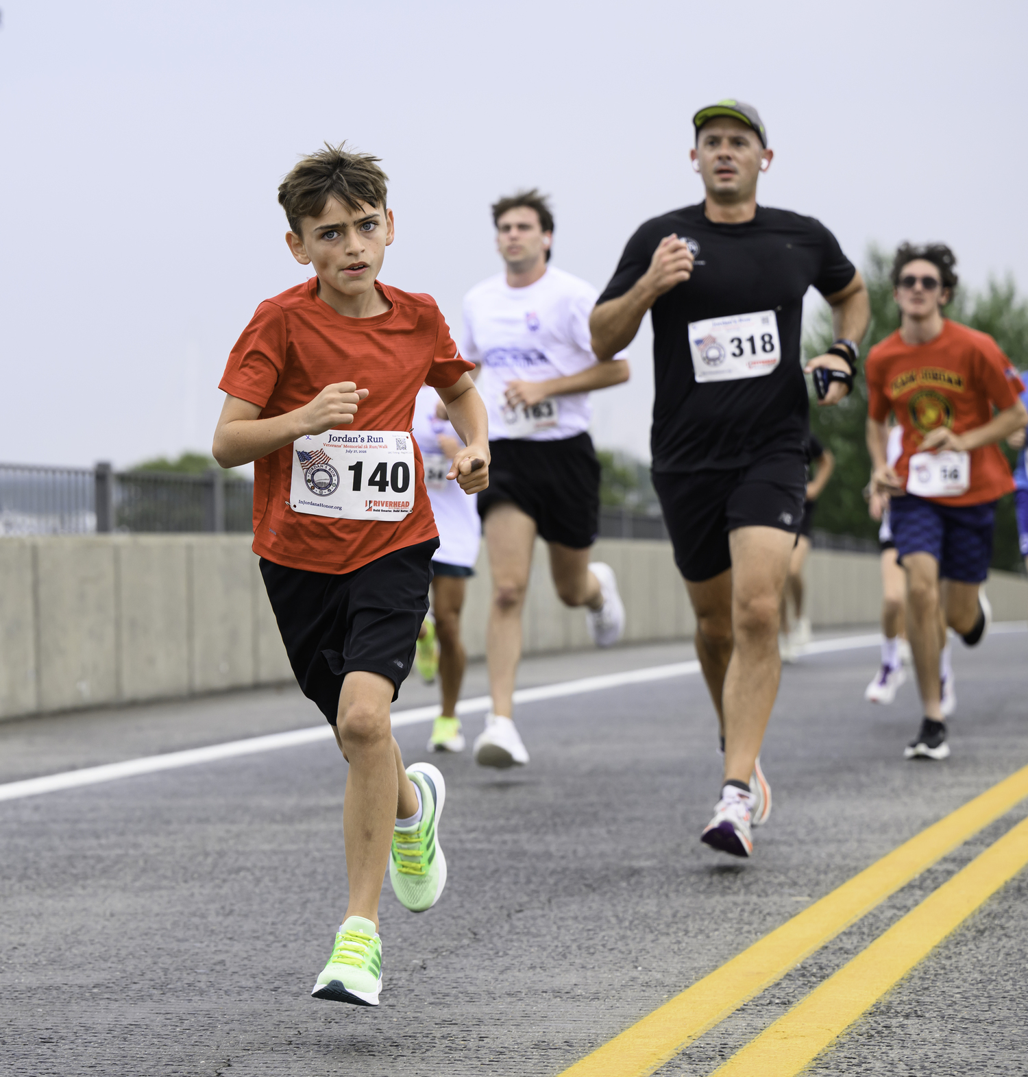 A young runner heads over the bridge.  MARIANNE BARNETT