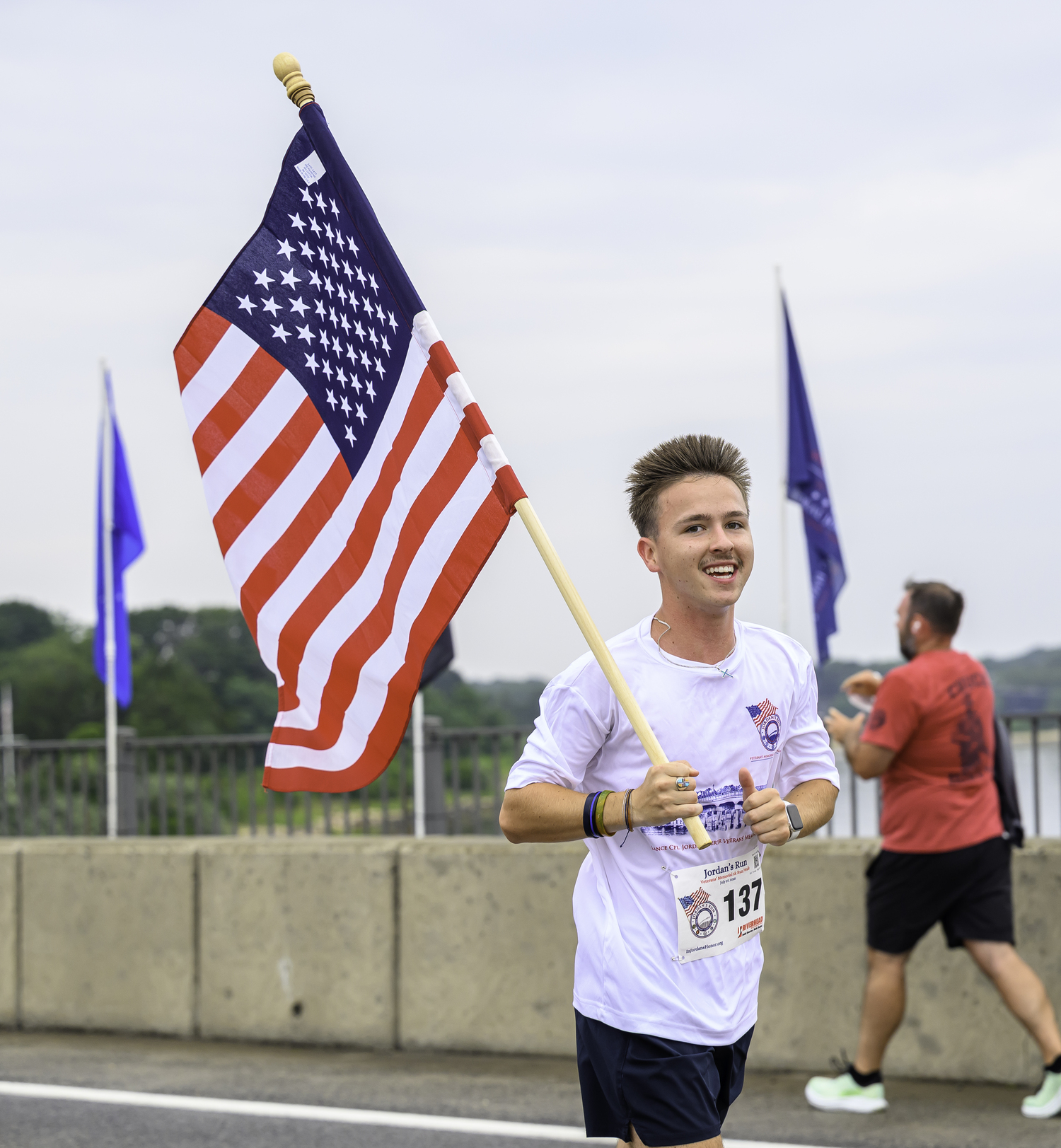 Connor Denison of Sag Harbor runs with the flag.  MARIANNE BARNETT