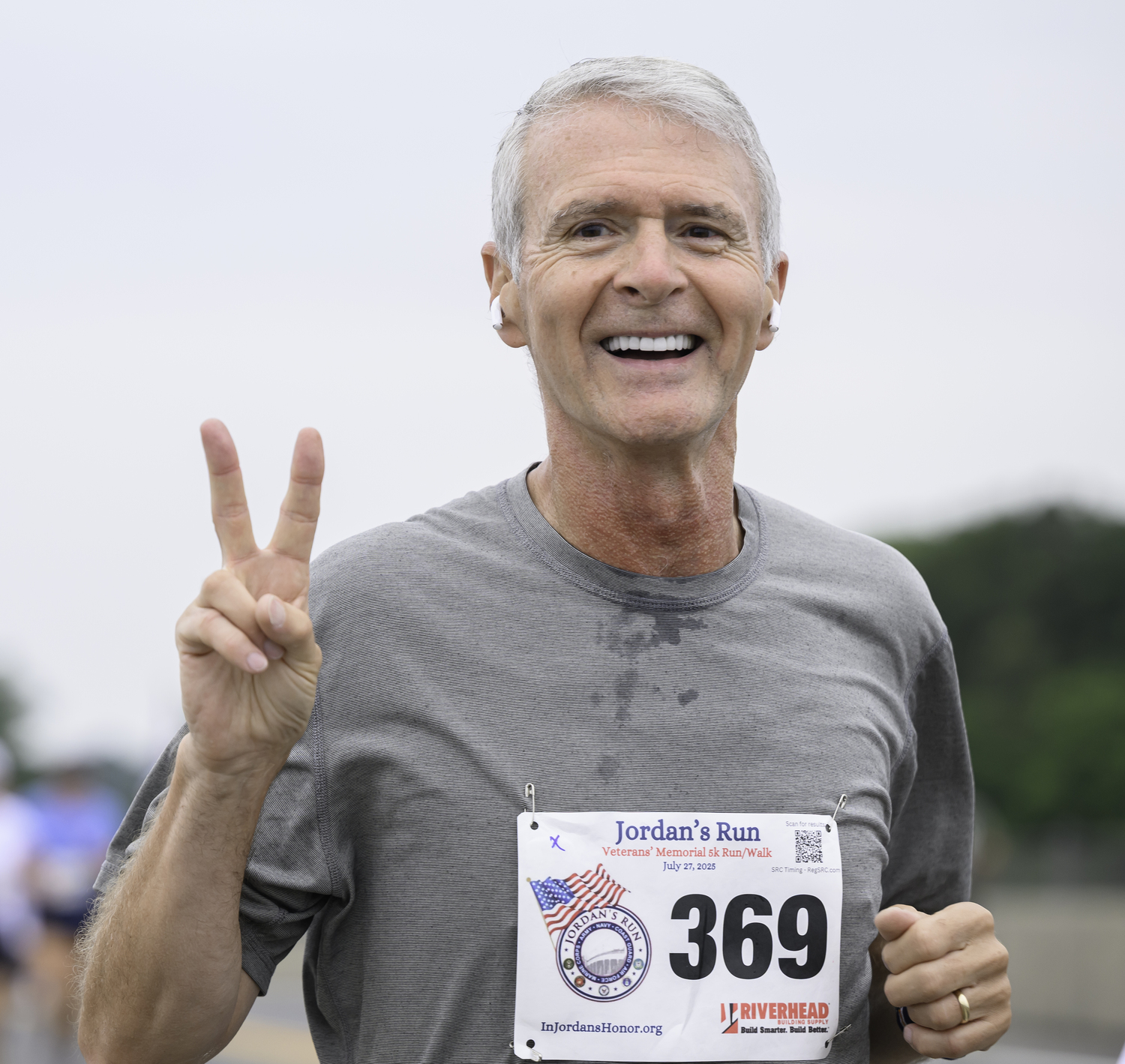 Tony Shepherd of Brooklyn flashes the peace sign heading over the bridge.   MARIANNE BARNETT