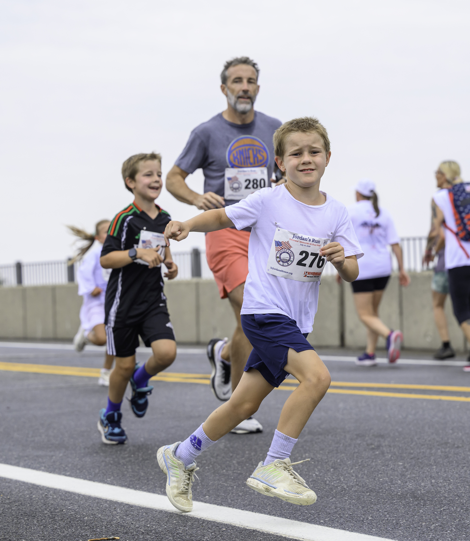 A young runner heads over the bridge.  MARIANNE BARNETT