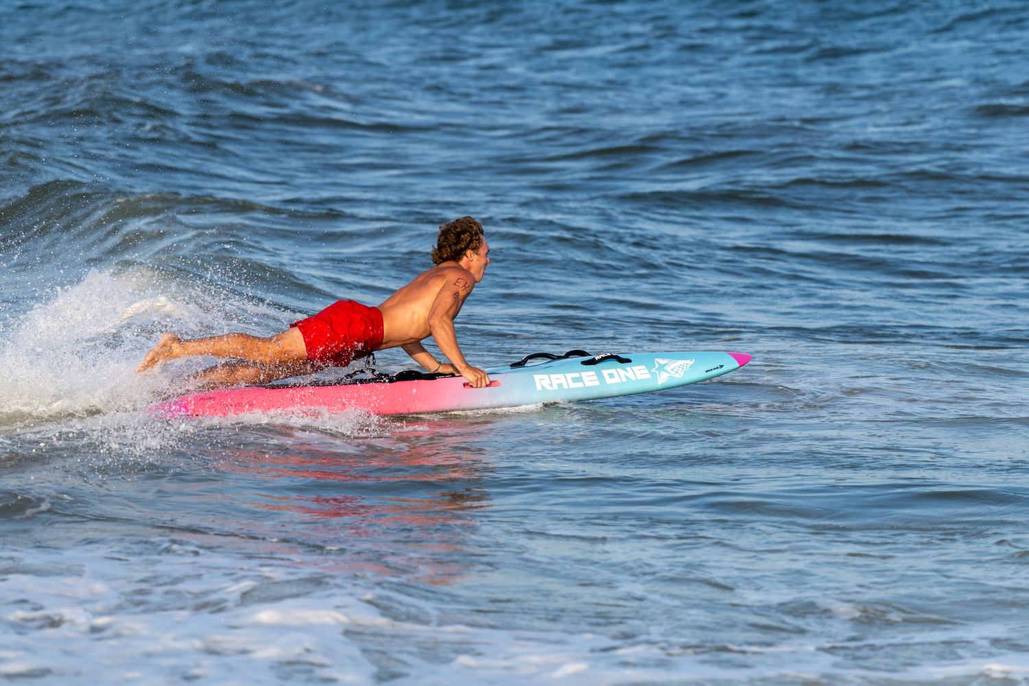An East Hampton Town lifeguard competing in the rescue board relay.  RON ESPOSITO