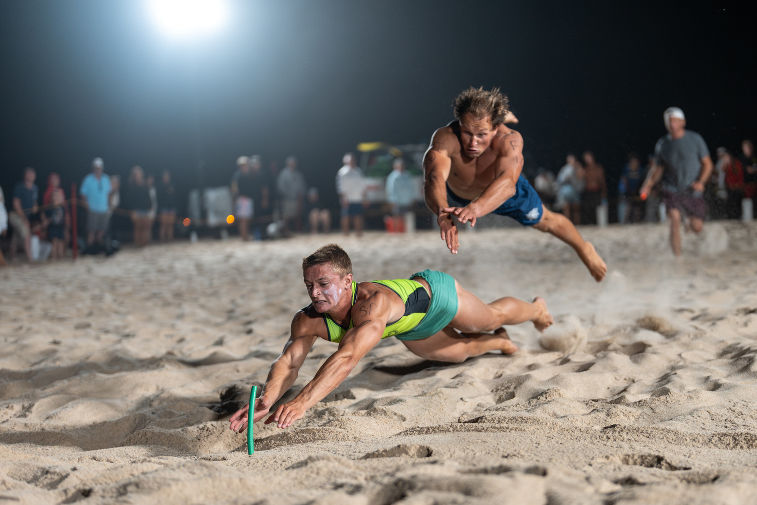 Smith Point lifeguard Matthew Kotch beats a Fire Island lifeguard to the beach flag.  RON ESPOSITO