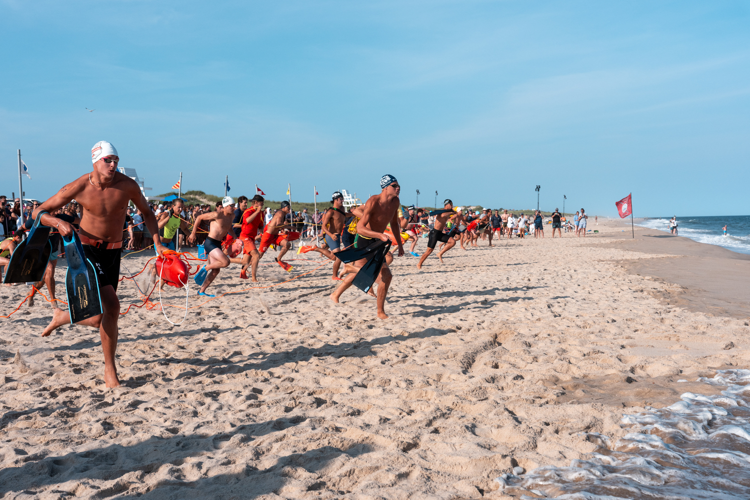 Lifeguards head out into the surf at the start of the landline rescue.  RON ESPOSITO