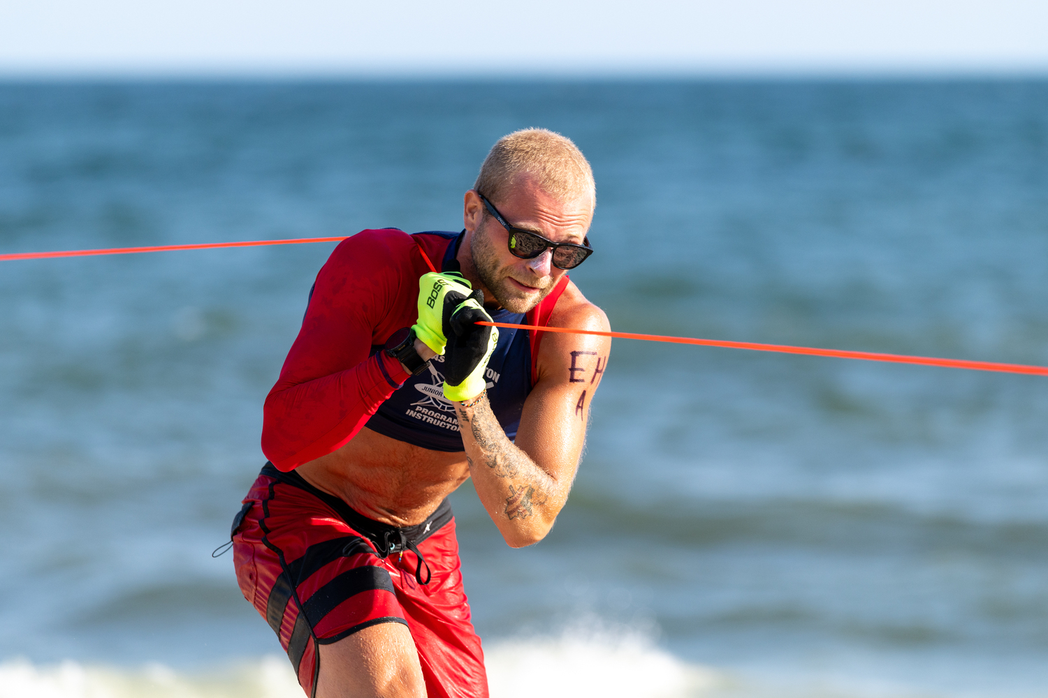 East Hampton Town lifeguard Tanner Smith working the lines in the landline rescue.  RON ESPOSITO