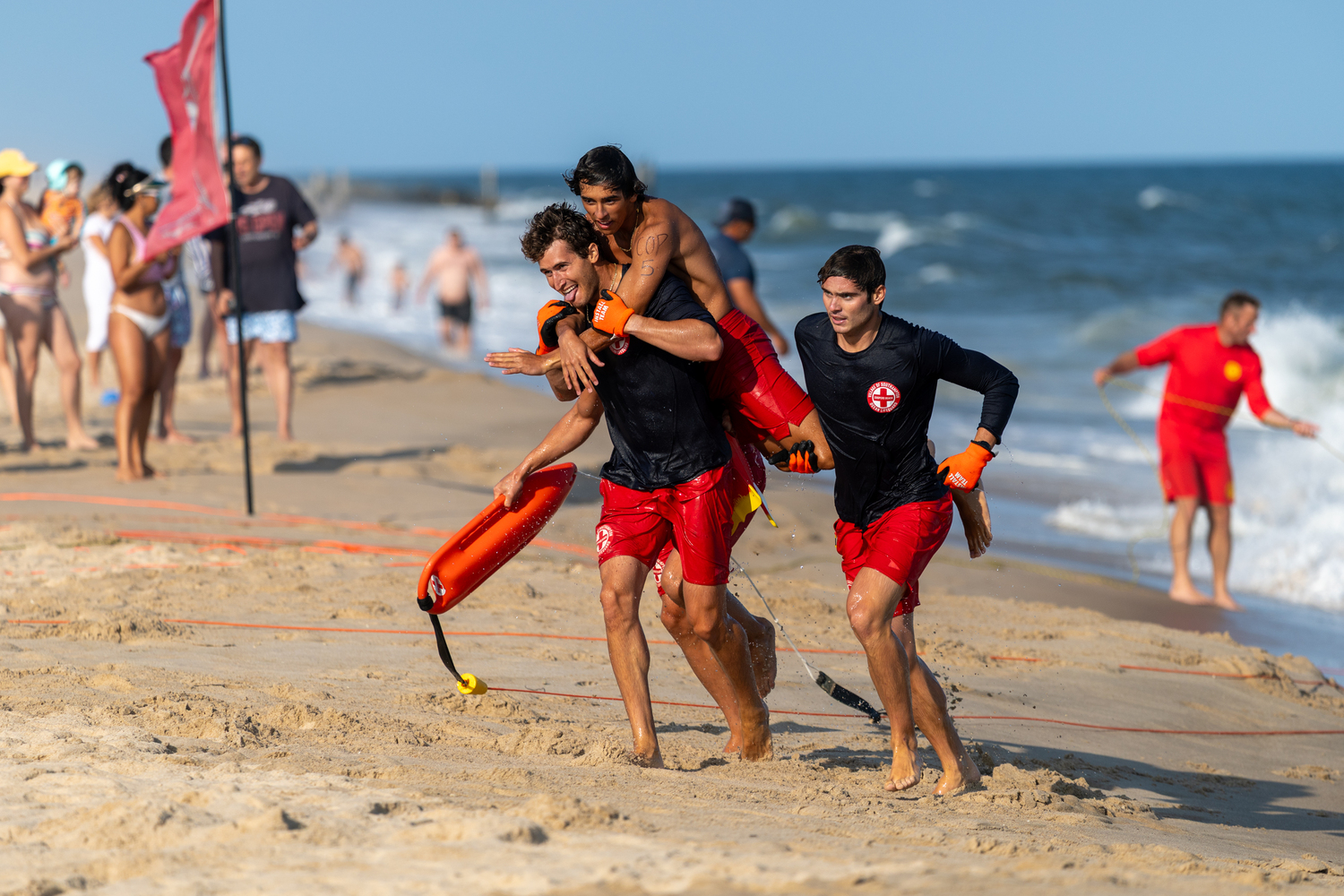A group of Coopers Beach lifeguards compete in the landline rescue.   RON ESPOSITO
