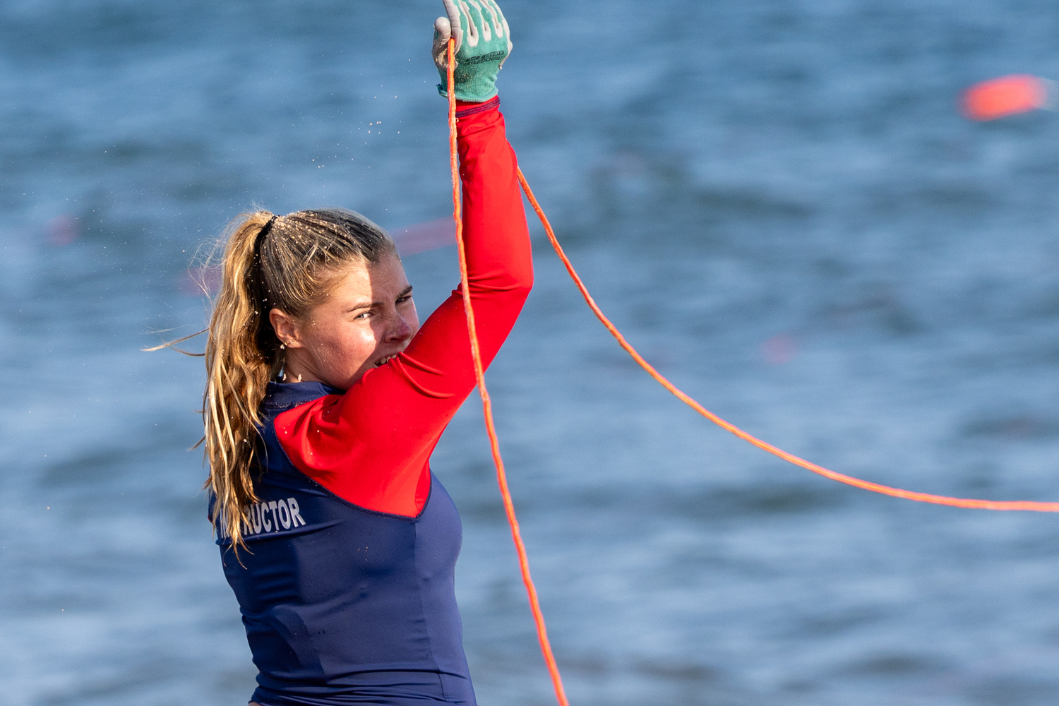 East Hampton Town lifeguard Ryleigh O'Donnell holds up a line in the landline rescue.  RON ESPOSITO