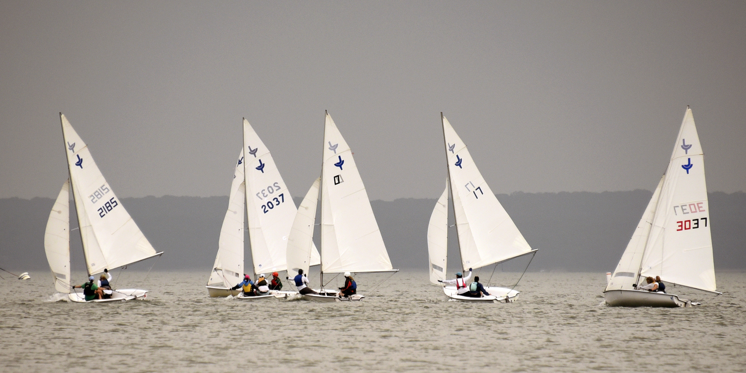 From left, Caitlin Cummings (crew: Elizabeth Cummings), second place Charlotte LeClue (sail #2037, crew: Josh LeClue), Jennifer Theiss (crew: Jennifer Amos Taylor), Sky Lilly Charles (crew: Breckin Lehnert), Amelia Steelman (crew: Derrick Galen) all sailing “wing and wing” for the leeward mark.  MICHAEL MELLA