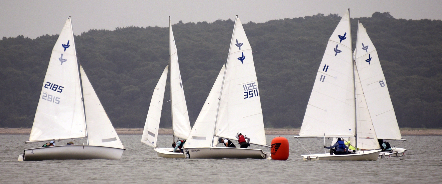 Close-quarter drill at the weather mark with Breakwater stalwart Sinéad FitzGibbon (sail #3511) and crew Mike Orchard center stage.  MICHAEL MELLA