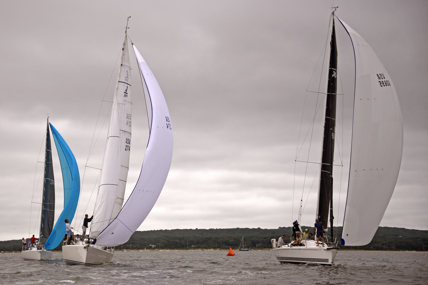 From left, Daniel Montero’s sixth place J-109 Holiday, Steve Kenny’s second place Gossip and Barry Browning’s eighth place X-Yachts XP 33 Tricky all fine tuning their spinnakers after rounding the weather mark. MICHAEL MELLA