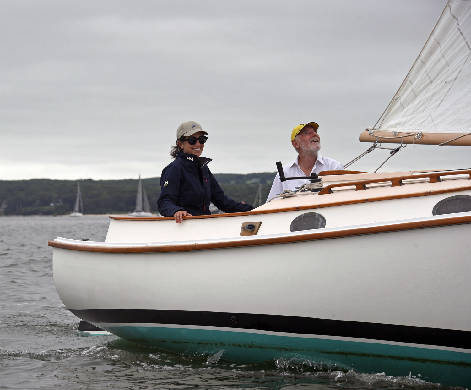 Jackie Rambo at the helm of her cat-rigged, gaff-head sail Herreshoff America while David Berridge takes a look at sail trim as they prepare for their 11:55 start time.  MICHAEL MELLA