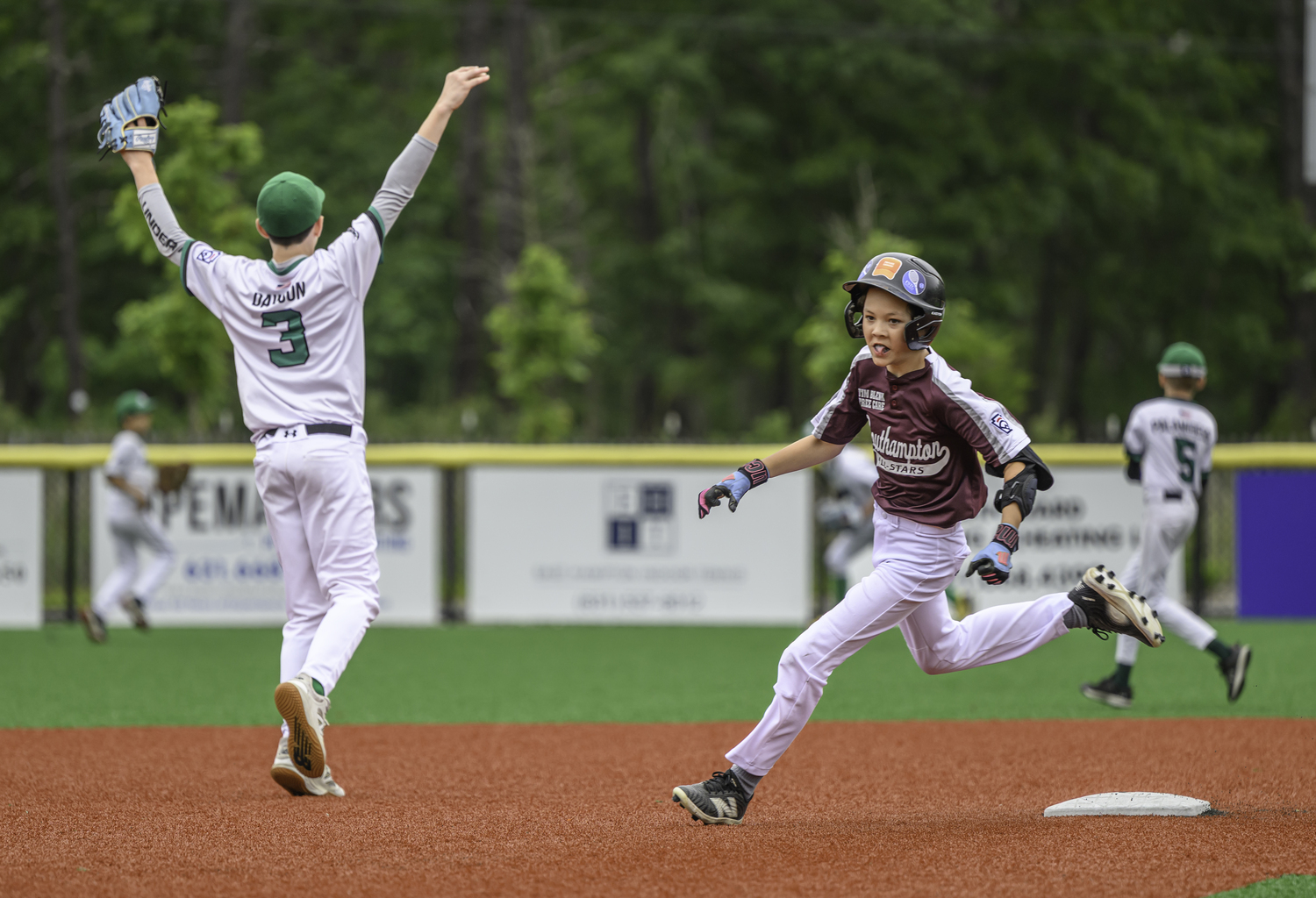 Finn Tiska rounds second base and heads to third on a ball hit to the outfield.  MARIANNE BARNETT