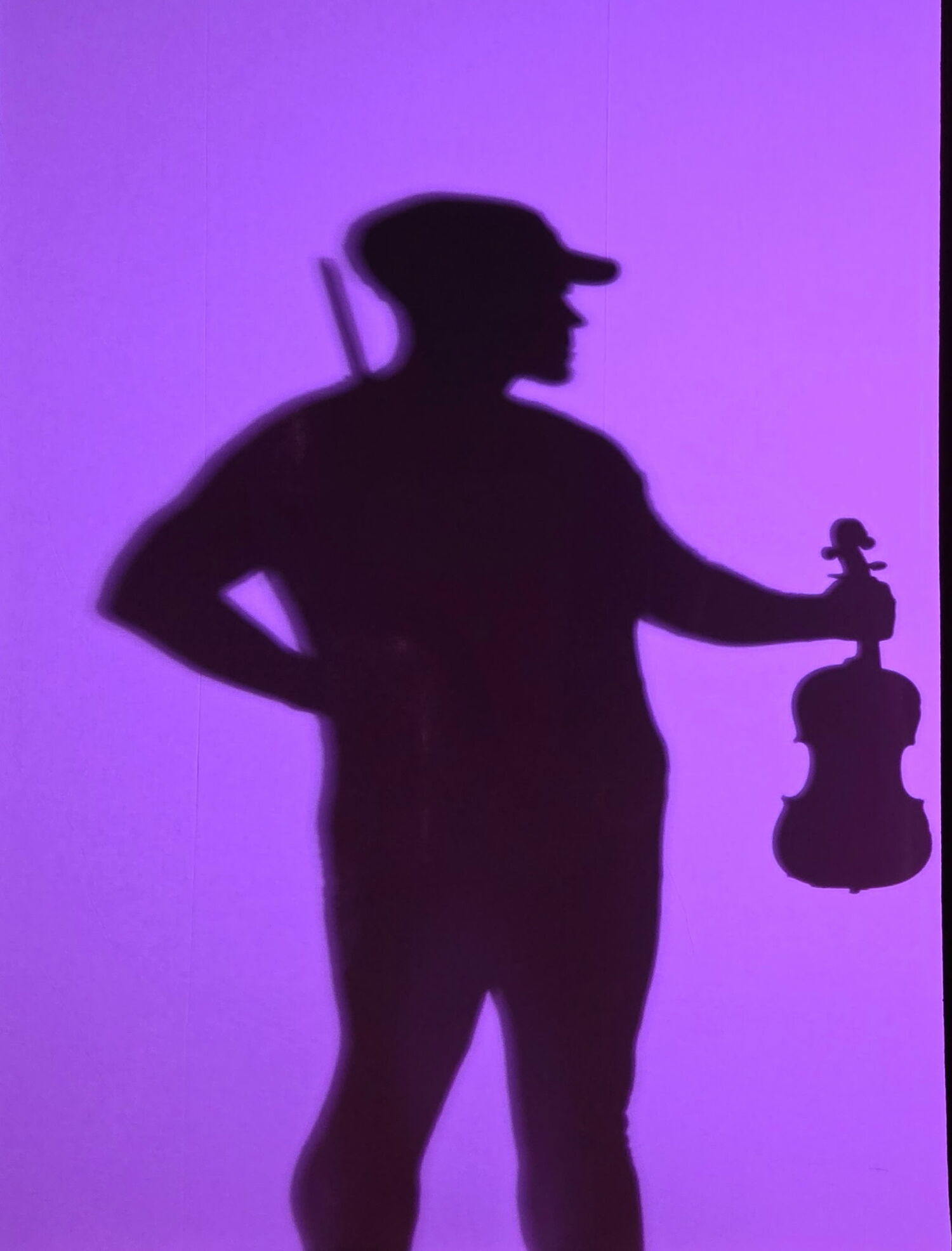Trent Firestine as the adult Soldier in Park Avenue Chamber Symphony's performance of Igor Stravinsky’s “The Soldier’s Tale.” The show, which uses extensive theatrical lighting and shadow puppetry, will be presented by Shelter Island Friends of Music on August 3. ADAM BUNDY